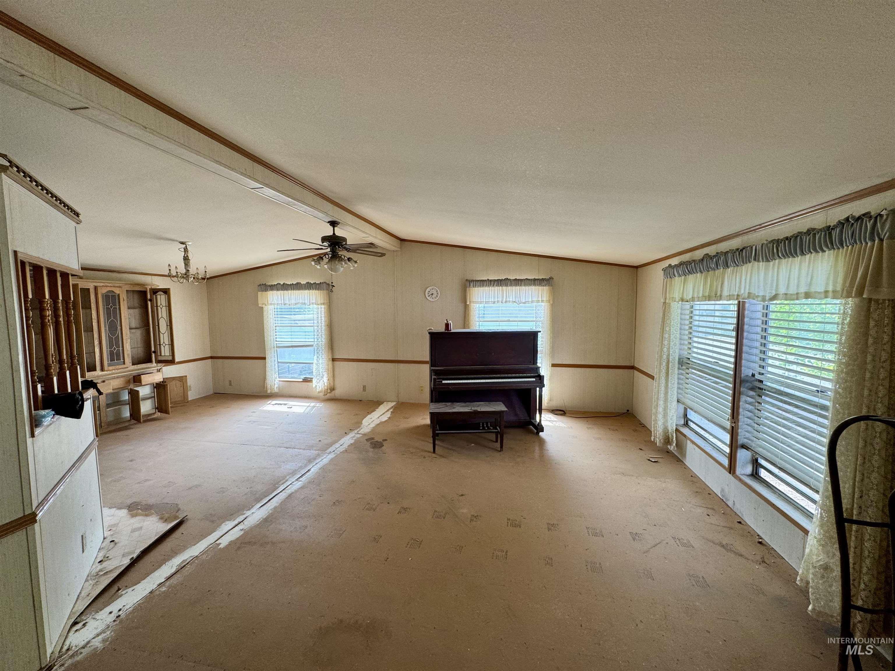 Sitting room featuring ceiling fan and a chandelier