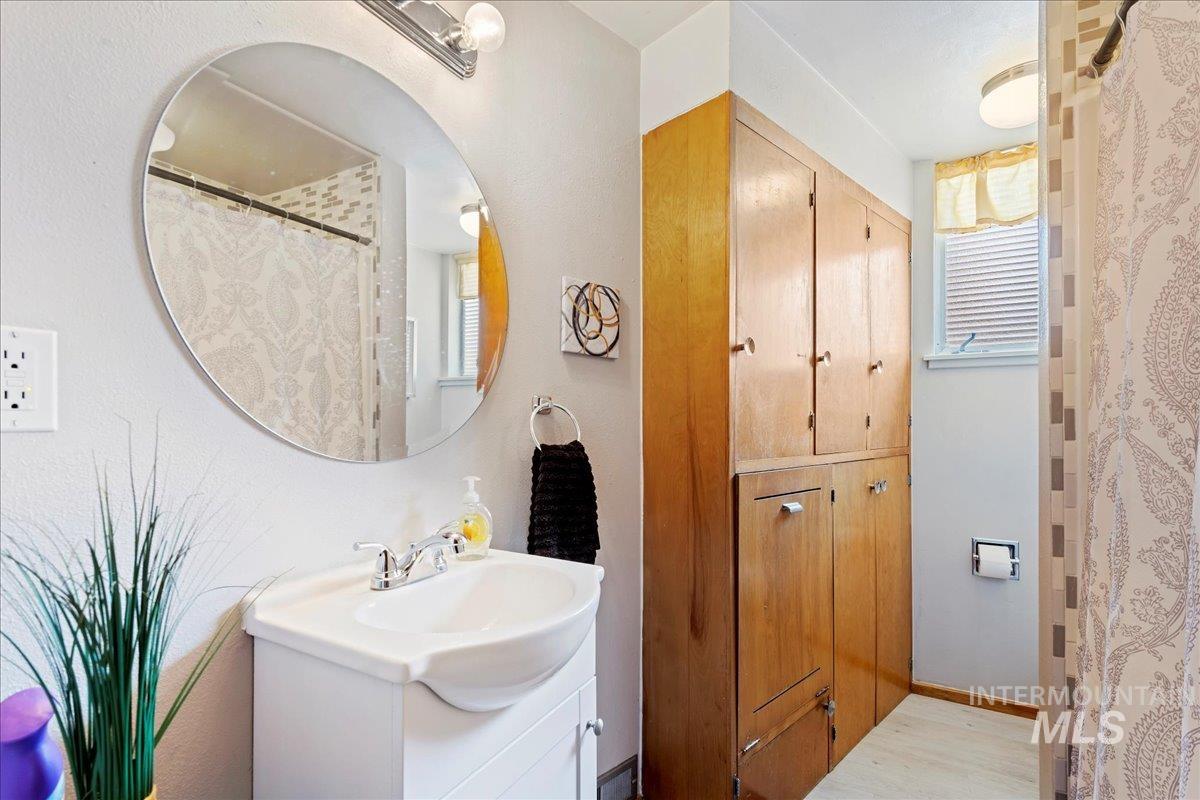 Full bathroom featuring vanity and light wood-style floors