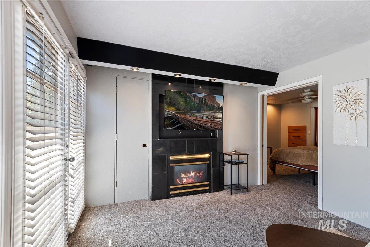 Carpeted bedroom featuring a fireplace