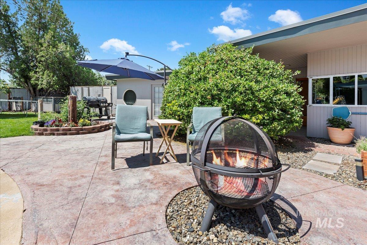 View of patio / terrace featuring a fire pit and a grill