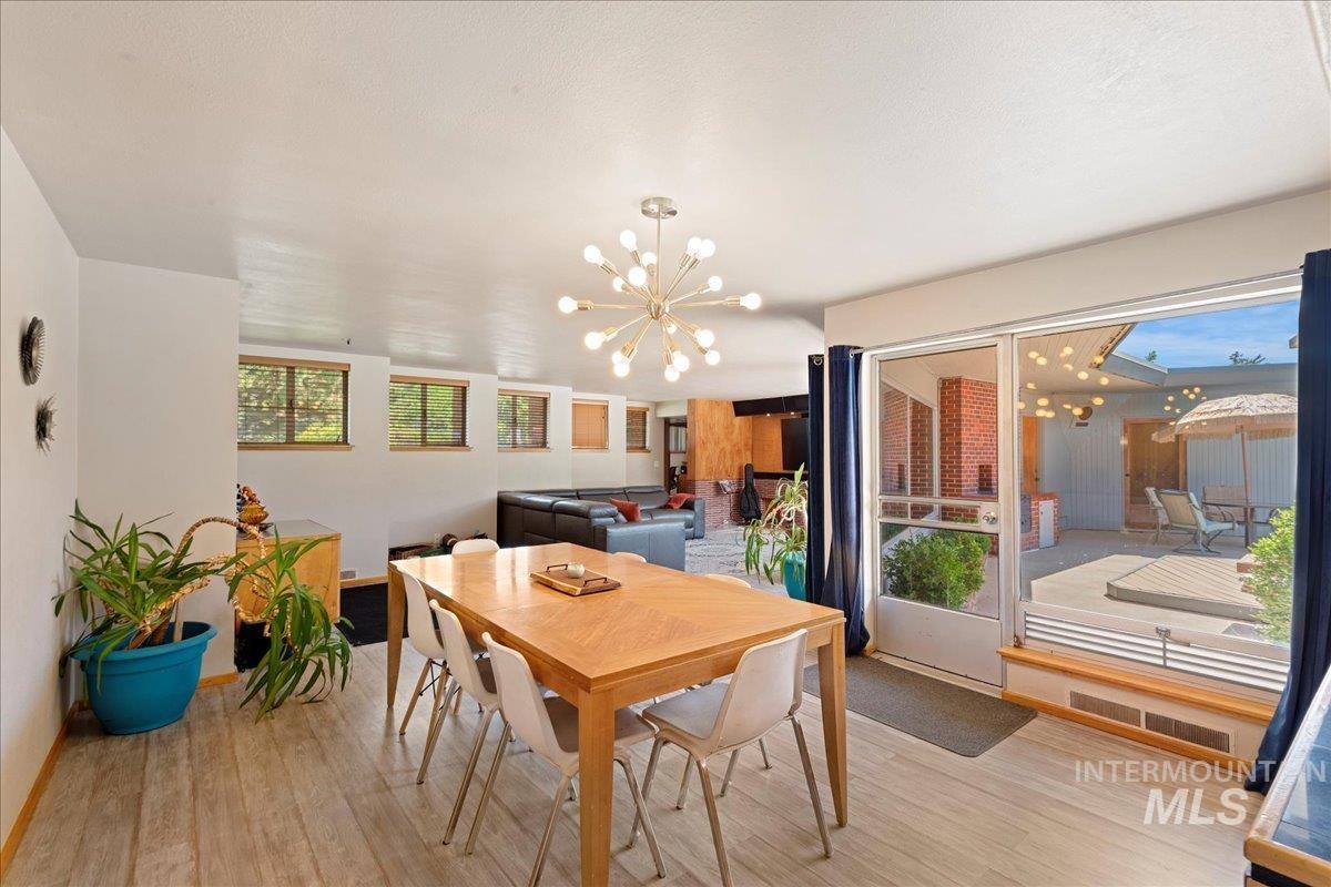 Dining space featuring a chandelier and light wood-style flooring