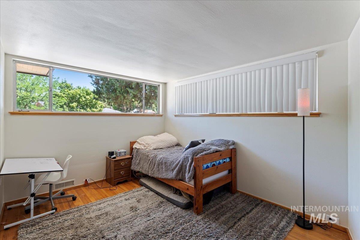 Bedroom featuring light wood-style floors and baseboards