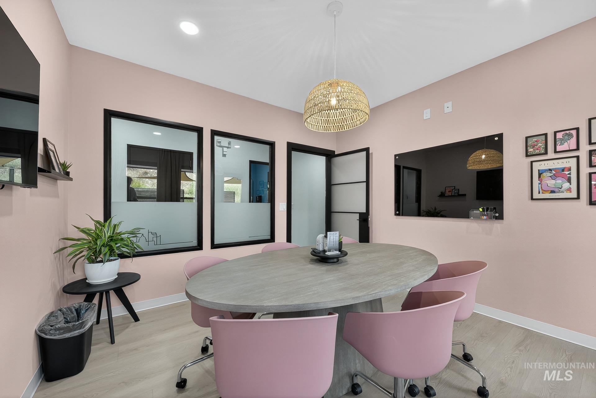 Dining area with light wood-type flooring and recessed lighting
