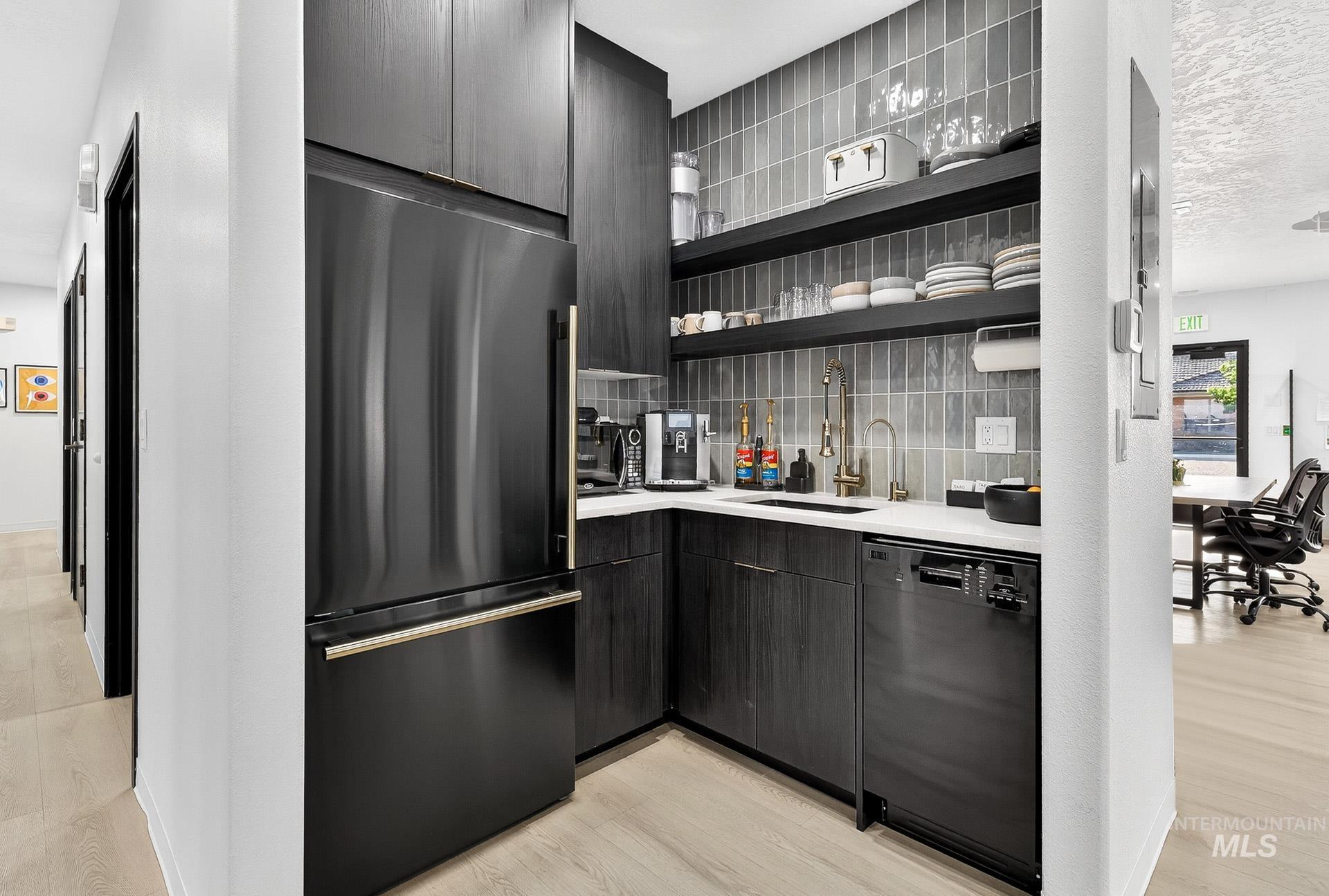 Kitchen featuring refrigerator, open shelves, light wood-style floors, modern cabinets, and a textured ceiling