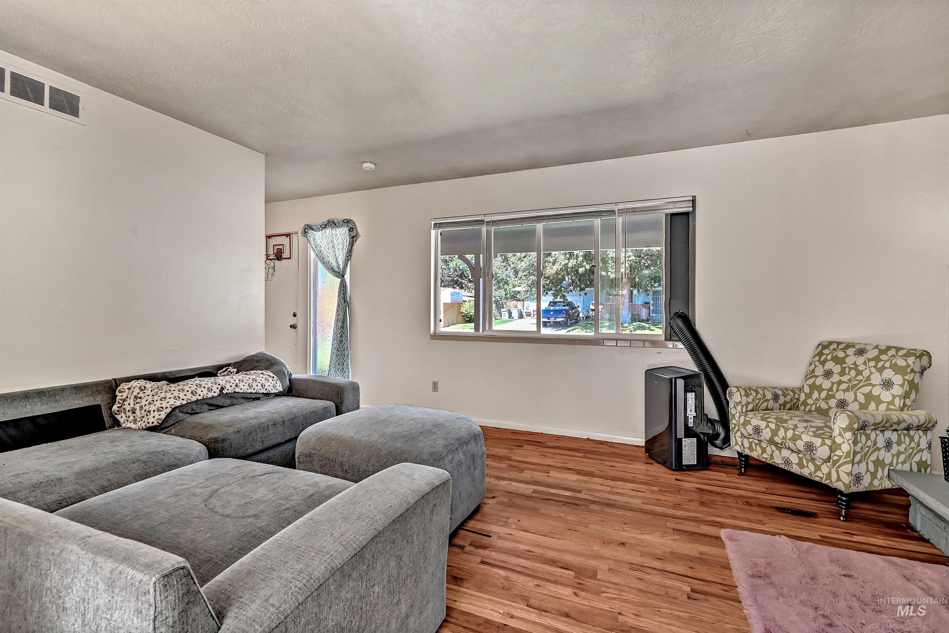Living area featuring wood finished floors and baseboards