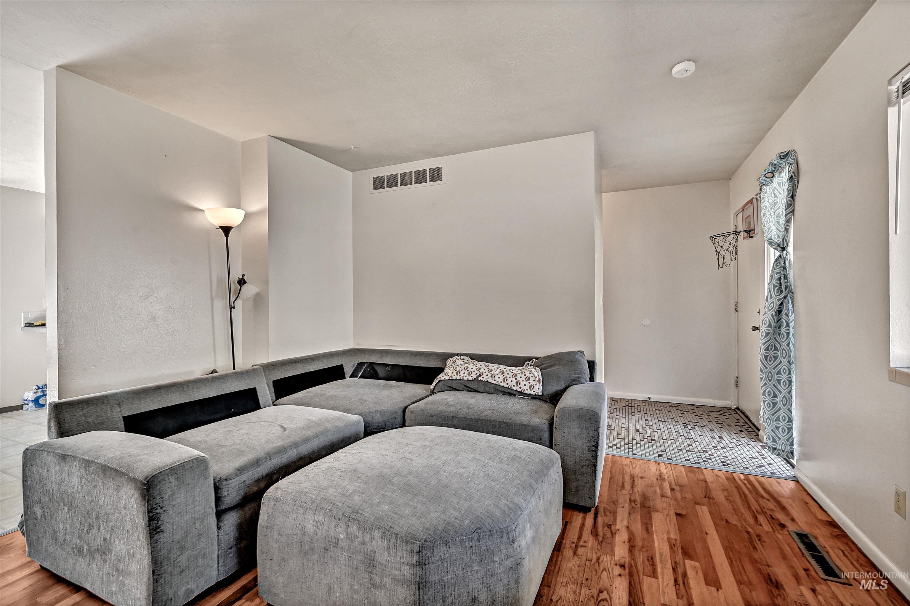 Living room with light wood-style floors and baseboards