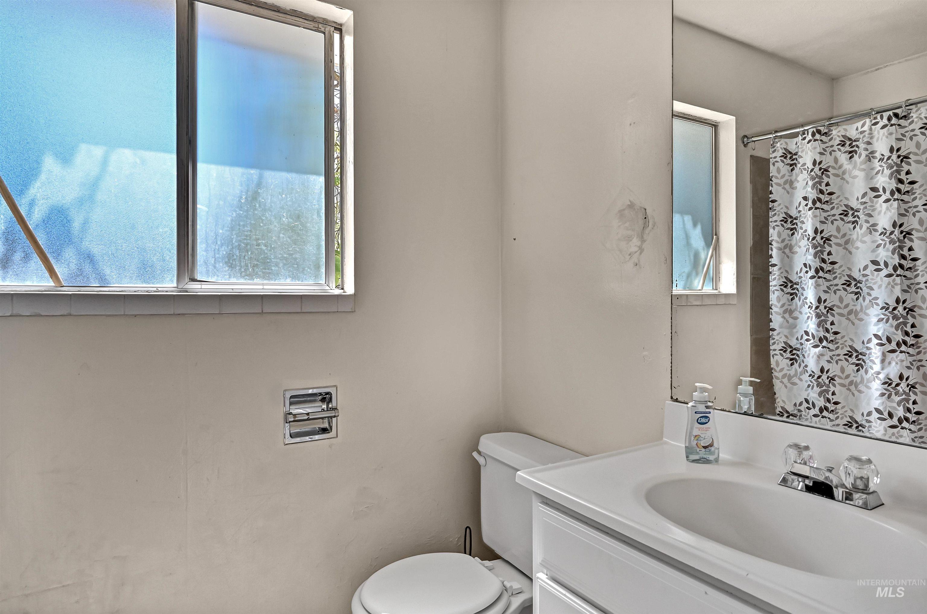 Full bath with vanity and curtained shower