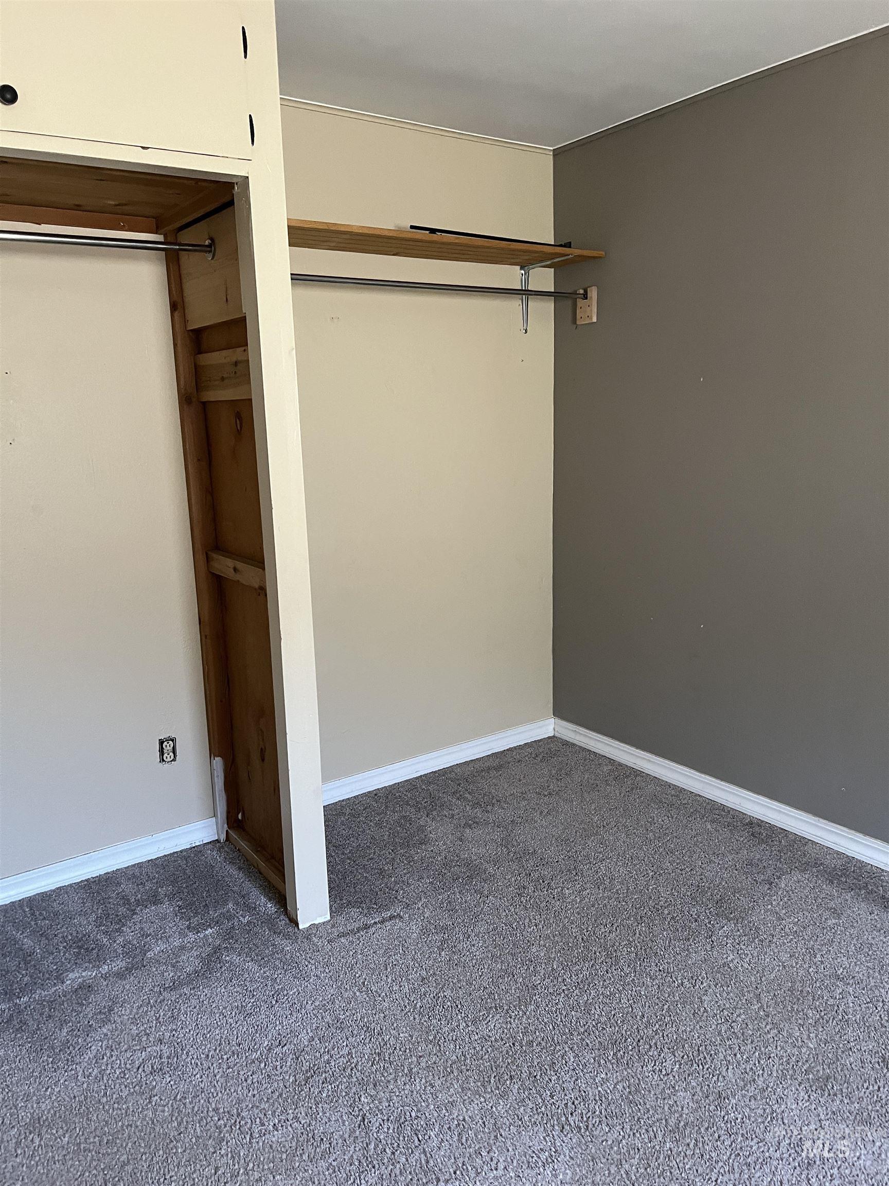 Unfurnished bedroom featuring carpet floors and baseboards