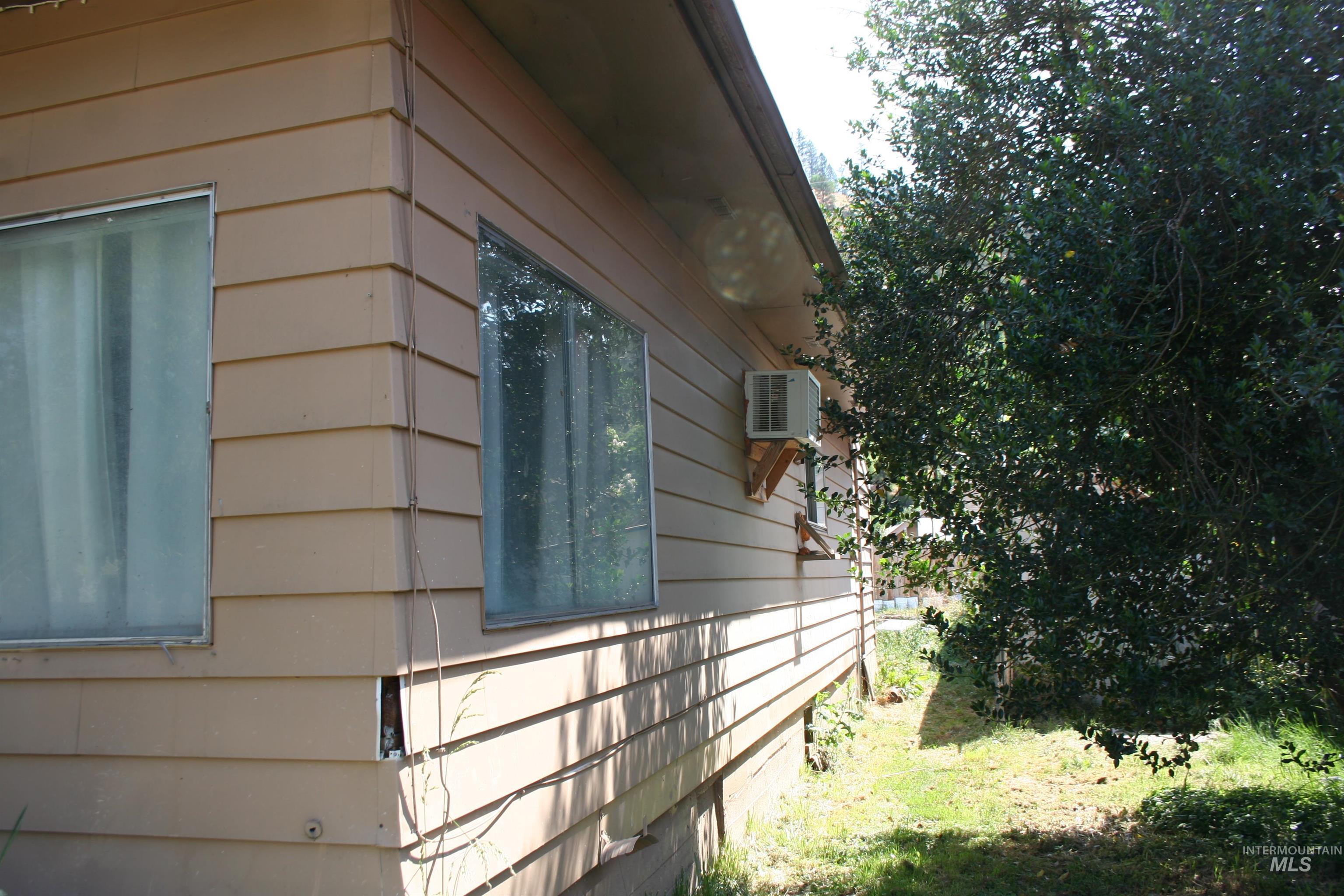 View of property exterior featuring a wall unit AC