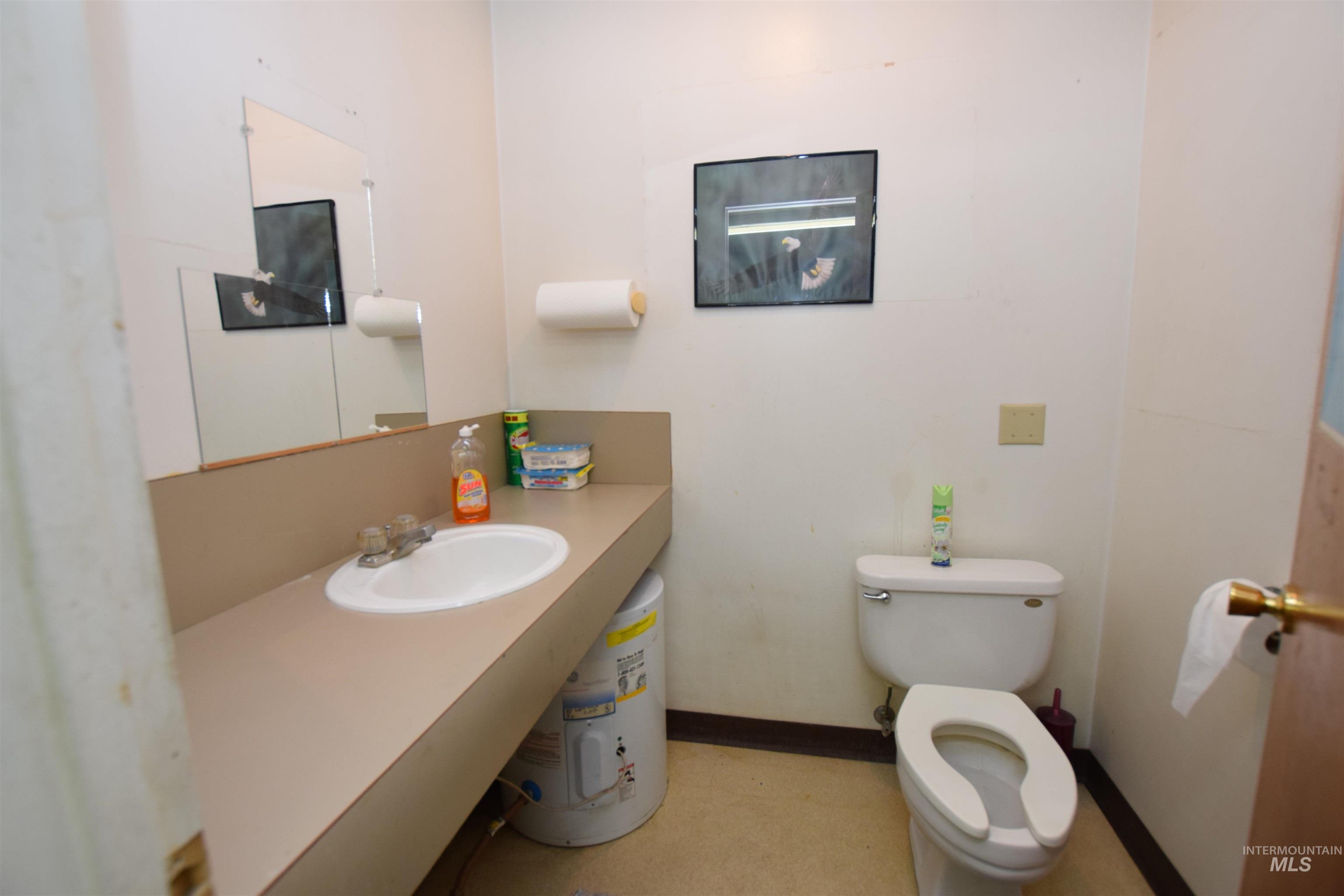 Half bath featuring water heater and vanity