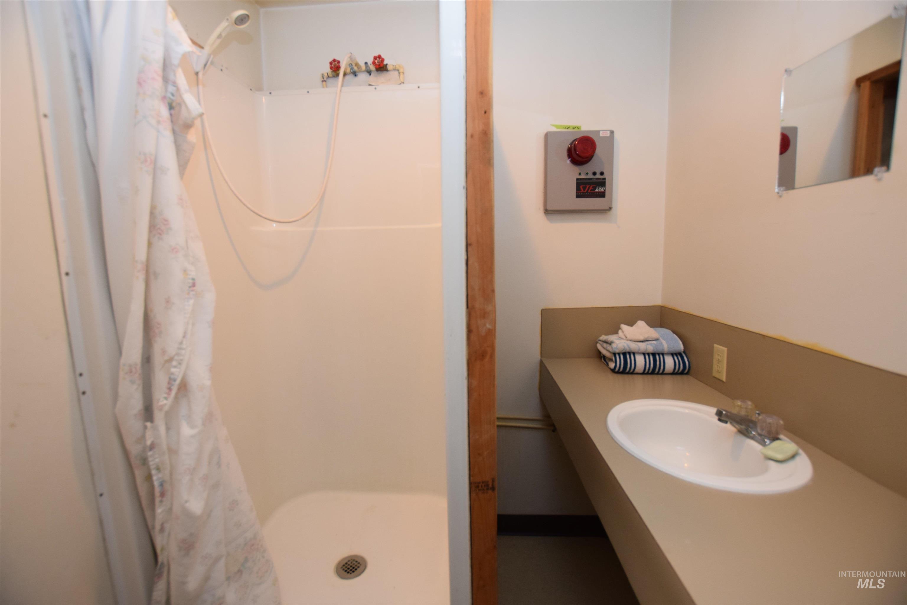 Full bath featuring a shower stall and vanity