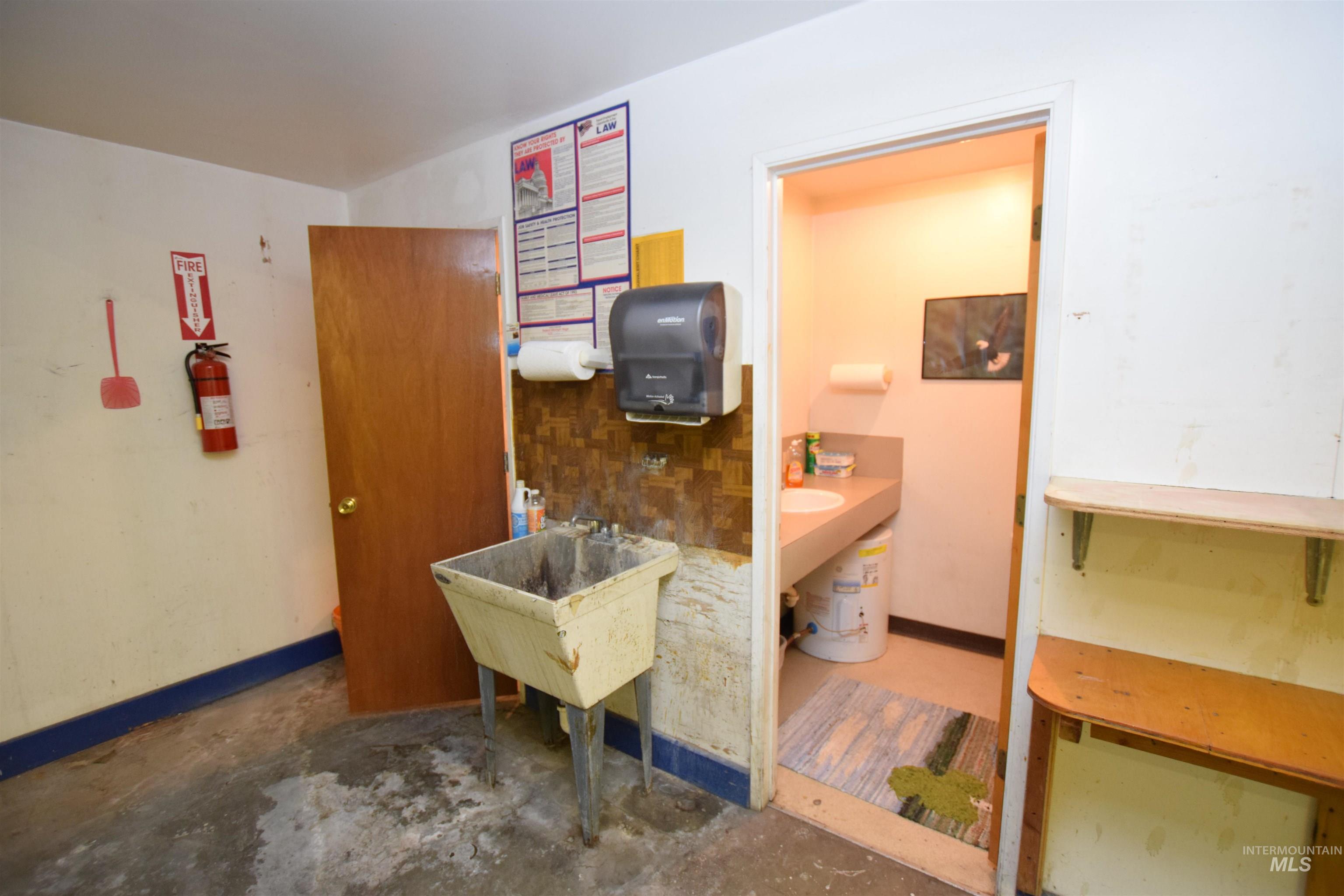 Kitchen featuring concrete floors and baseboards