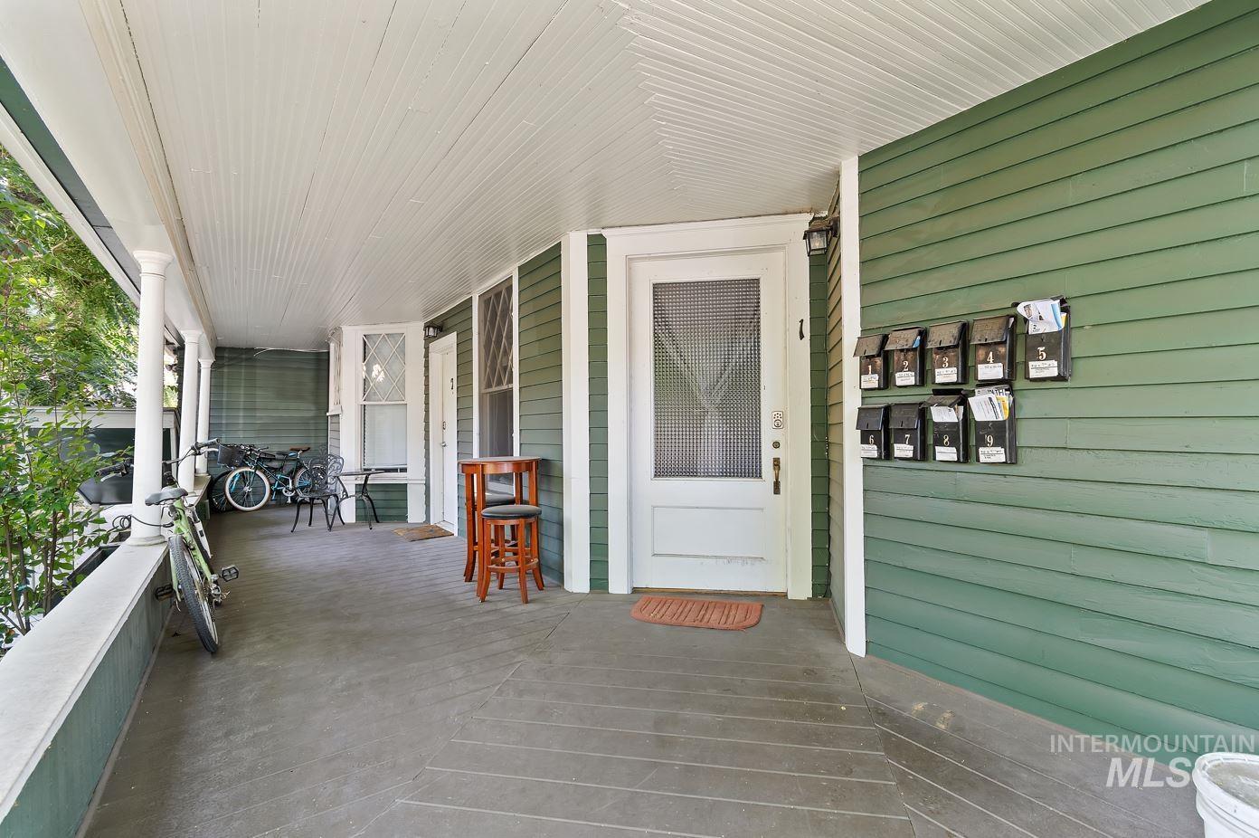 View of exterior entry featuring covered porch