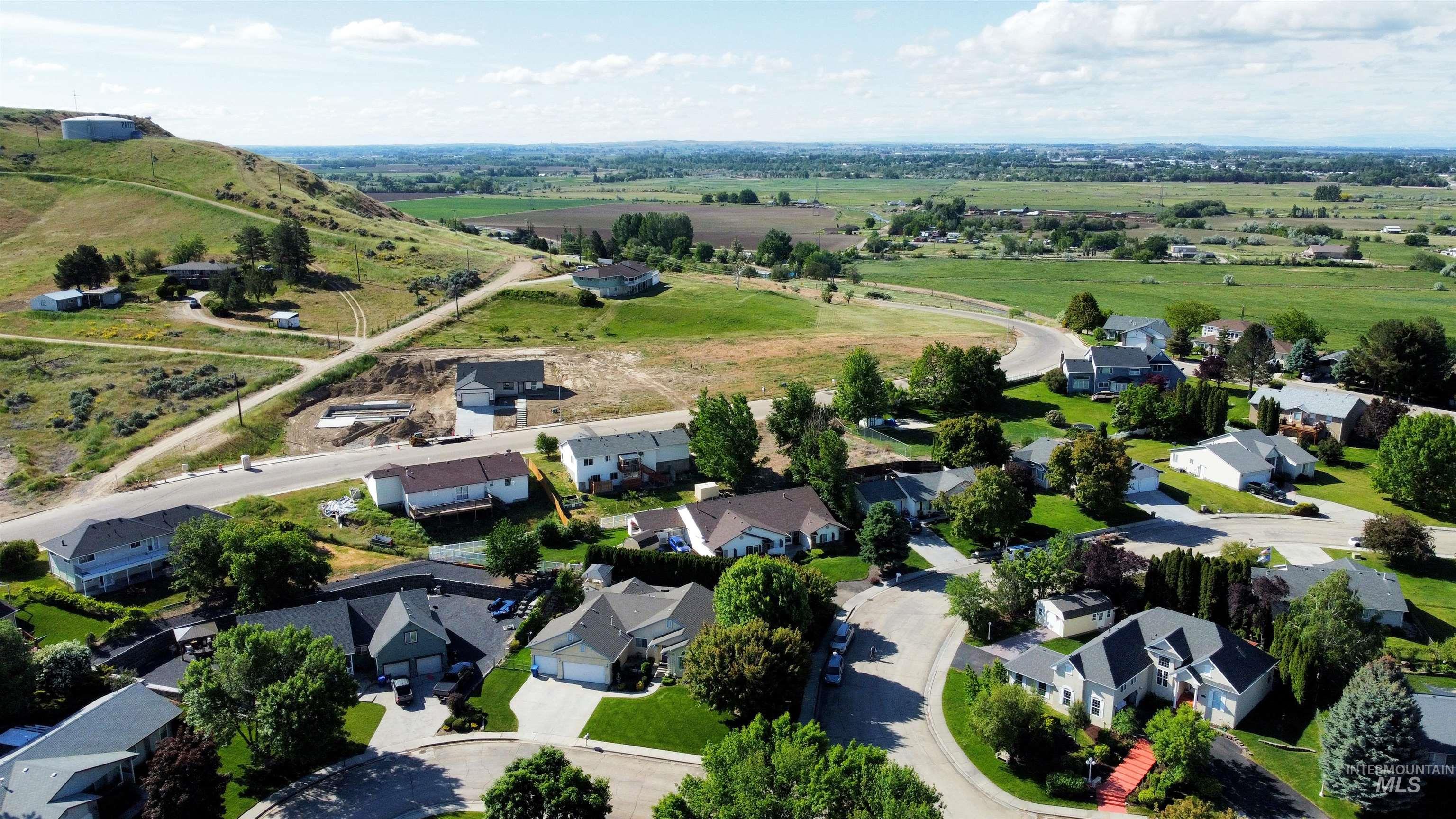 View of property location featuring nearby suburban area and rural landscape
