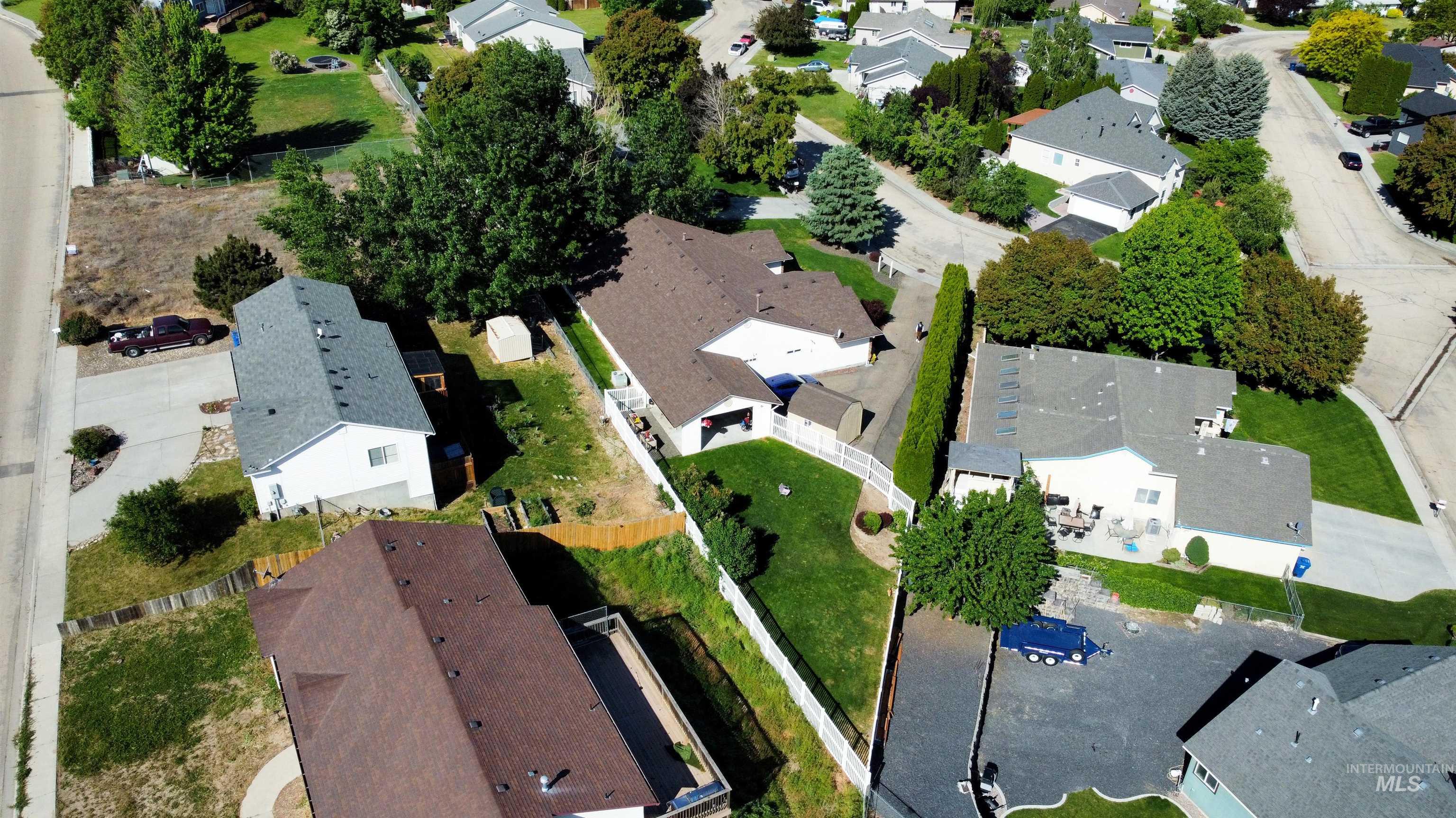Aerial view of property and surrounding area featuring nearby suburban area