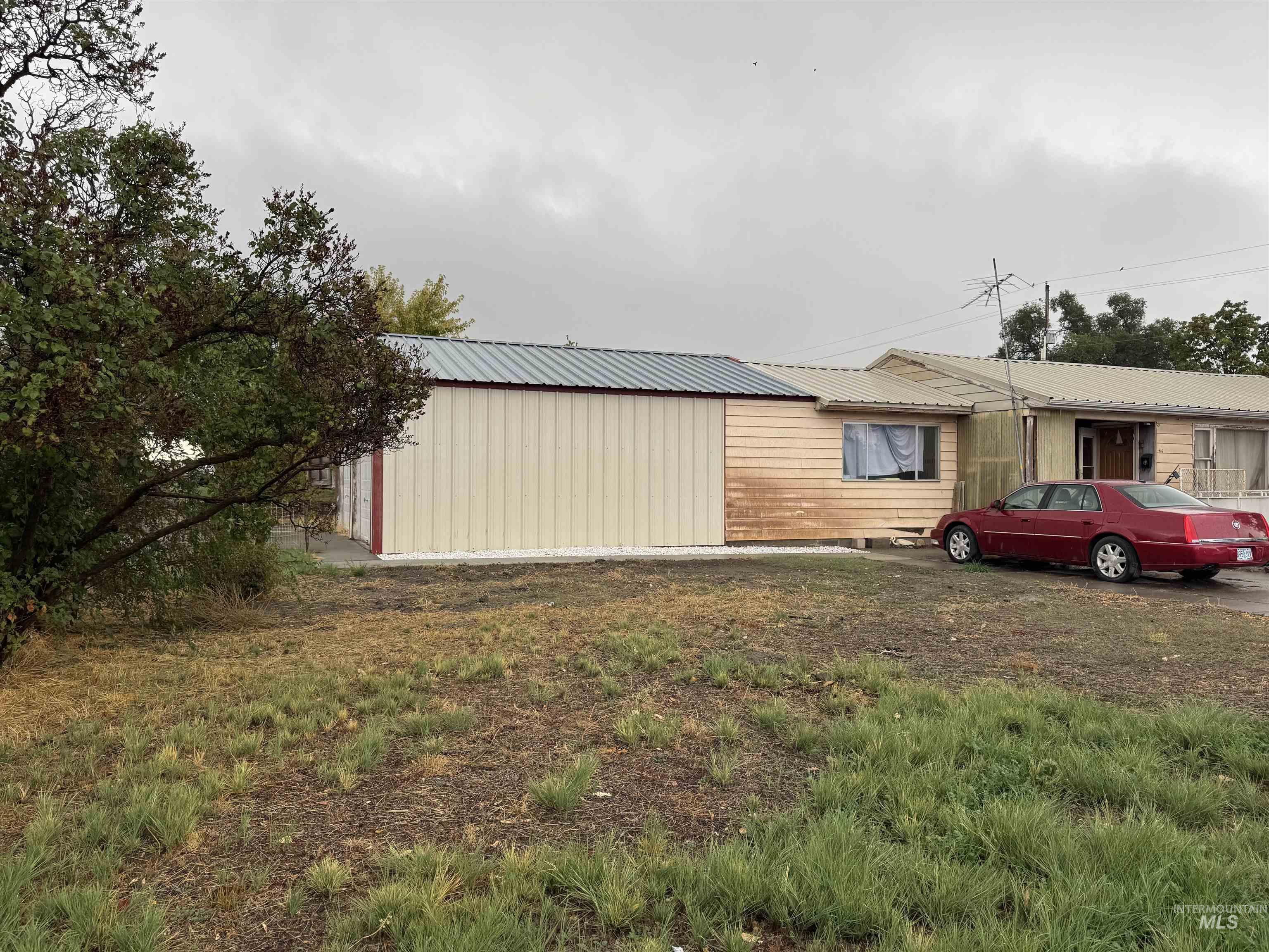View of side of property with a metal roof