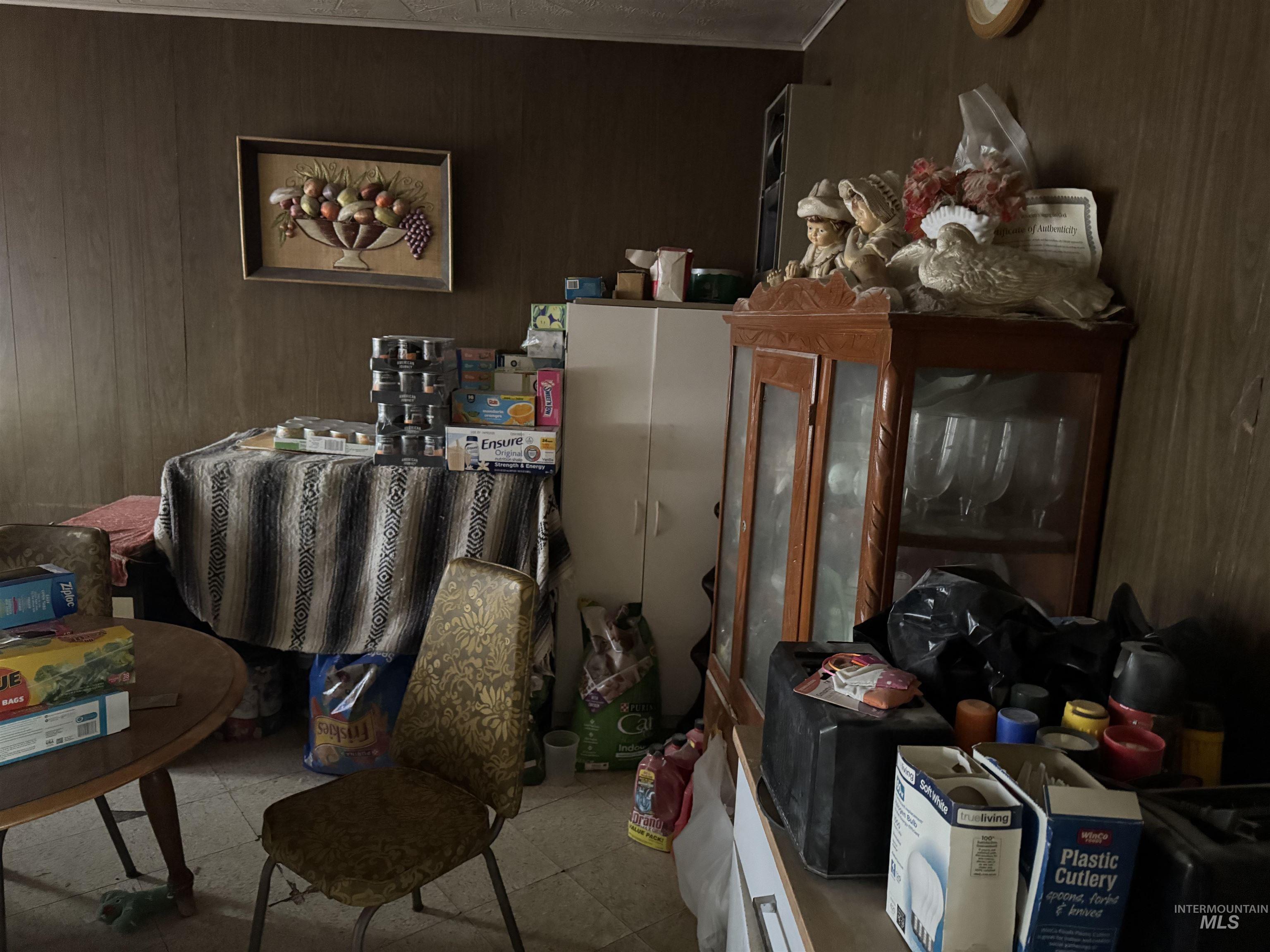 Miscellaneous room with wooden walls and tile patterned floors