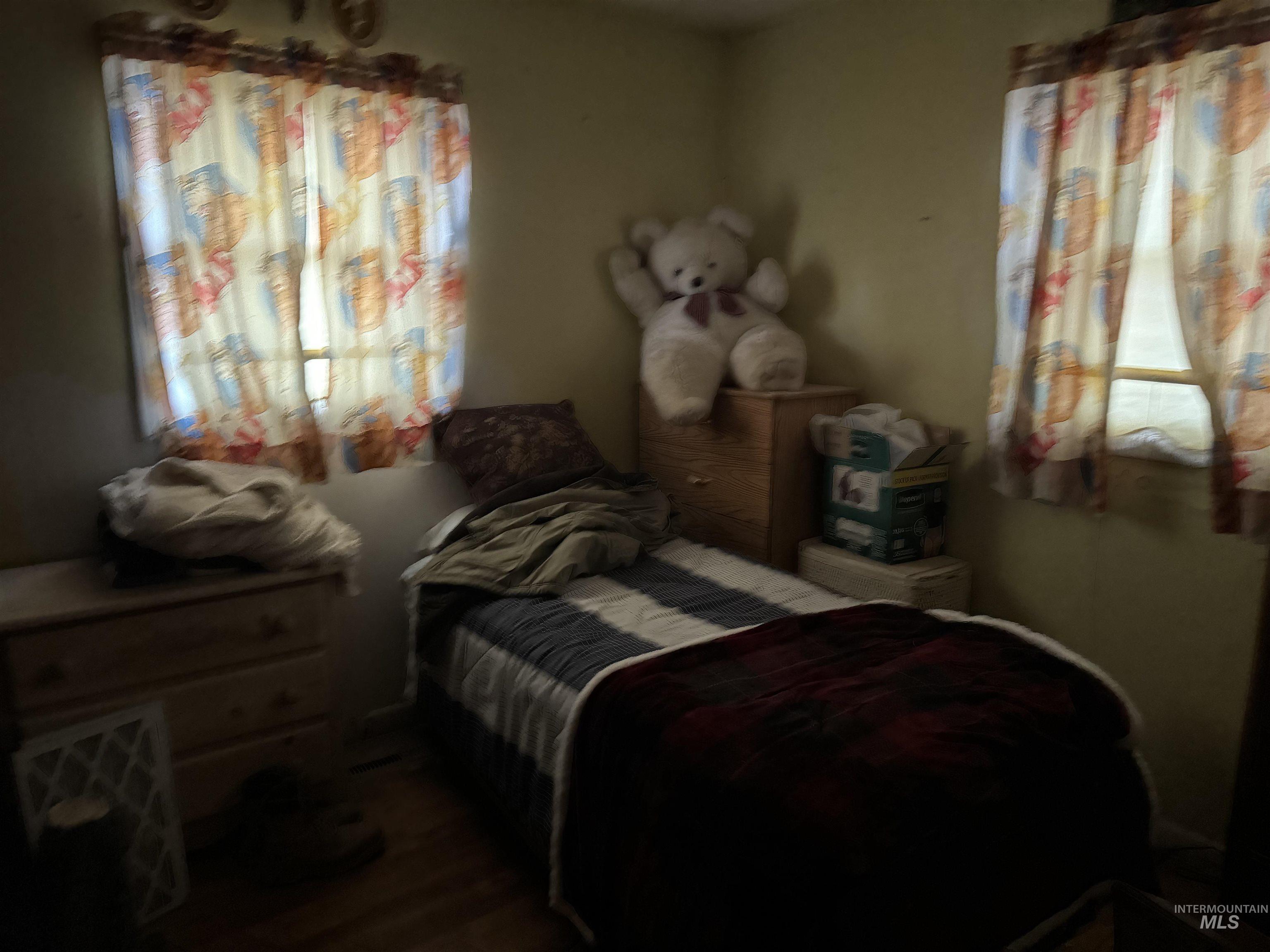 Bedroom featuring dark wood-style flooring