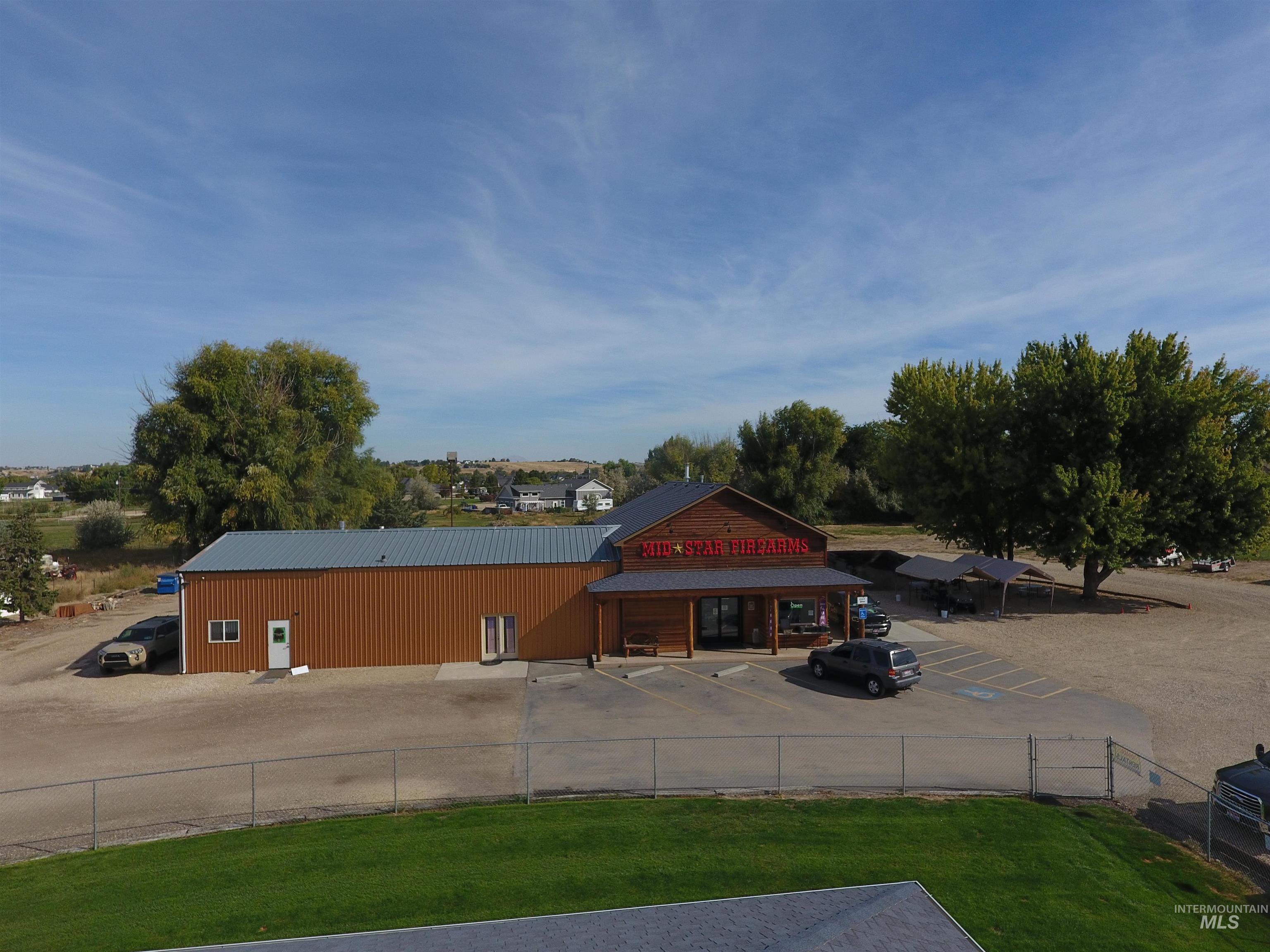 View of building exterior featuring uncovered parking
