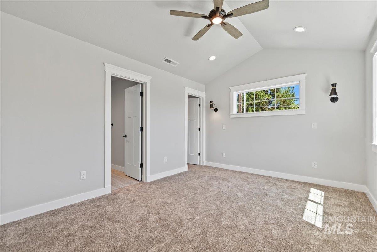 bedroom with light carpet, vaulted ceiling, recessed lighting, and ceiling fan