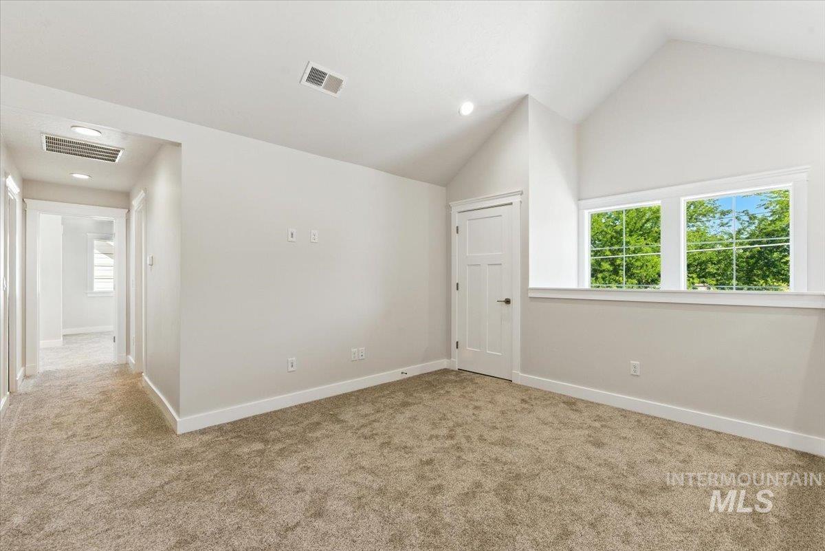 Loft featuring carpet floors, vaulted ceiling, recessed lighting and large walk-in closet