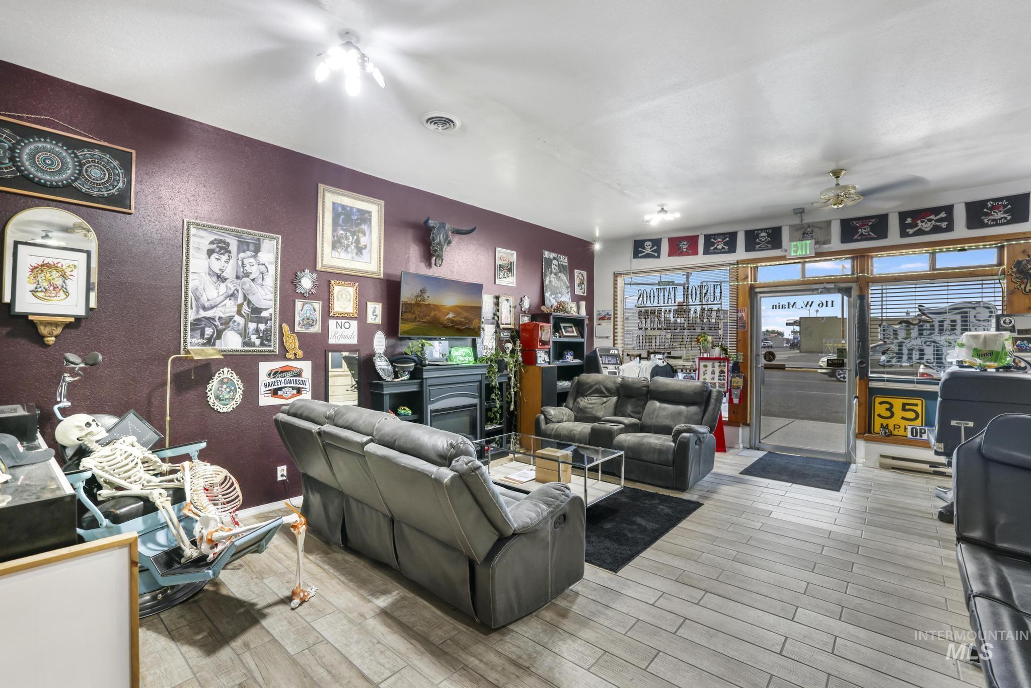Living area featuring ceiling fan and wood finished floors