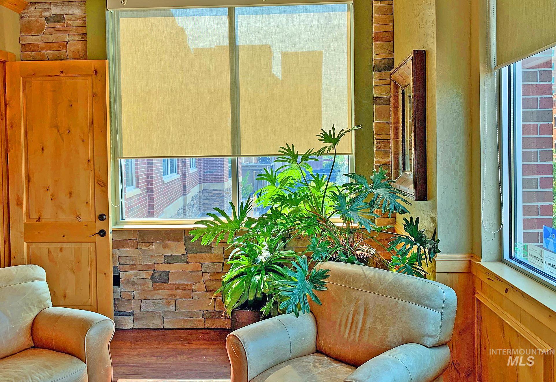 Sitting room with wood finished floors and wainscoting