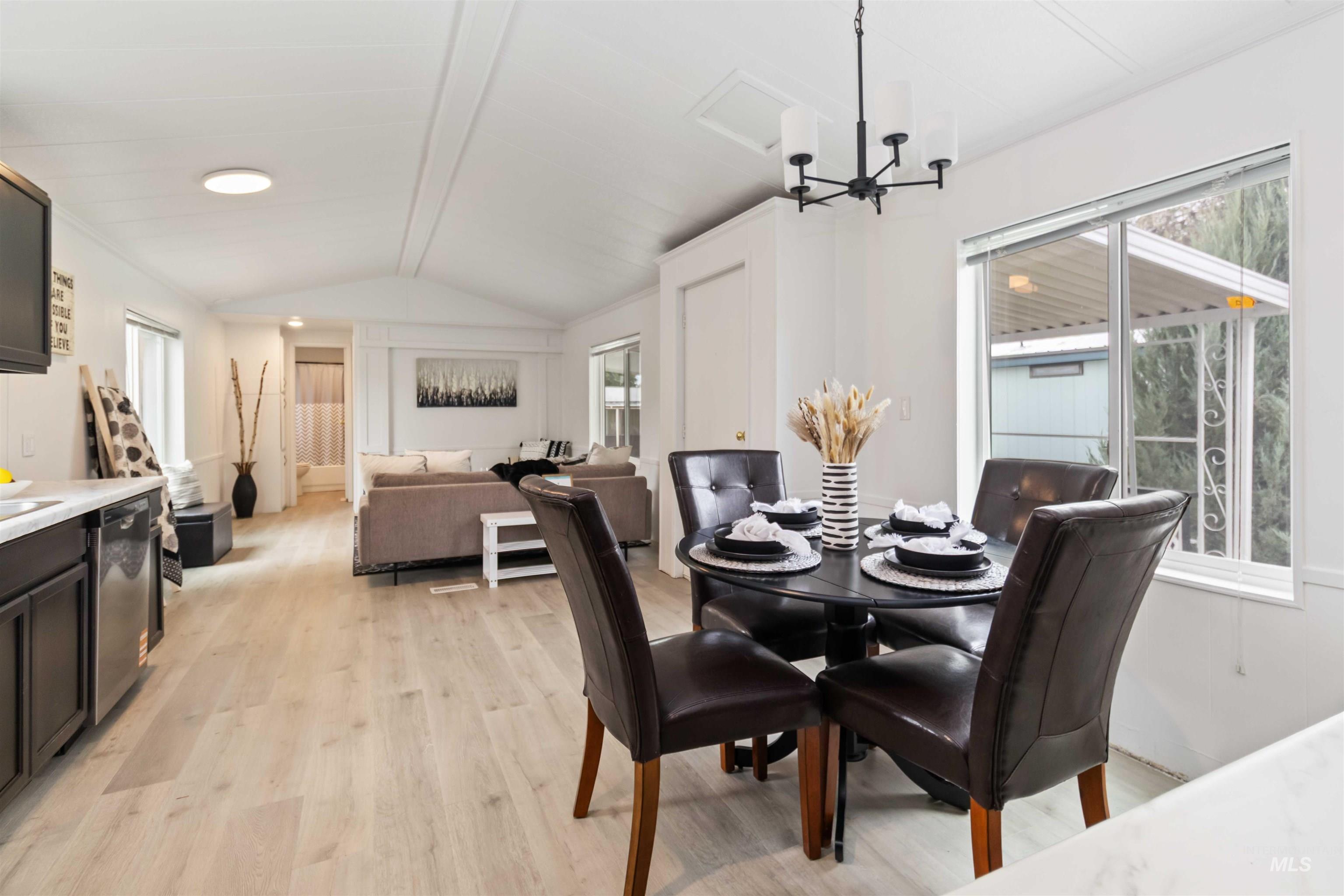 Dining room featuring light wood finished floors and a chandelier