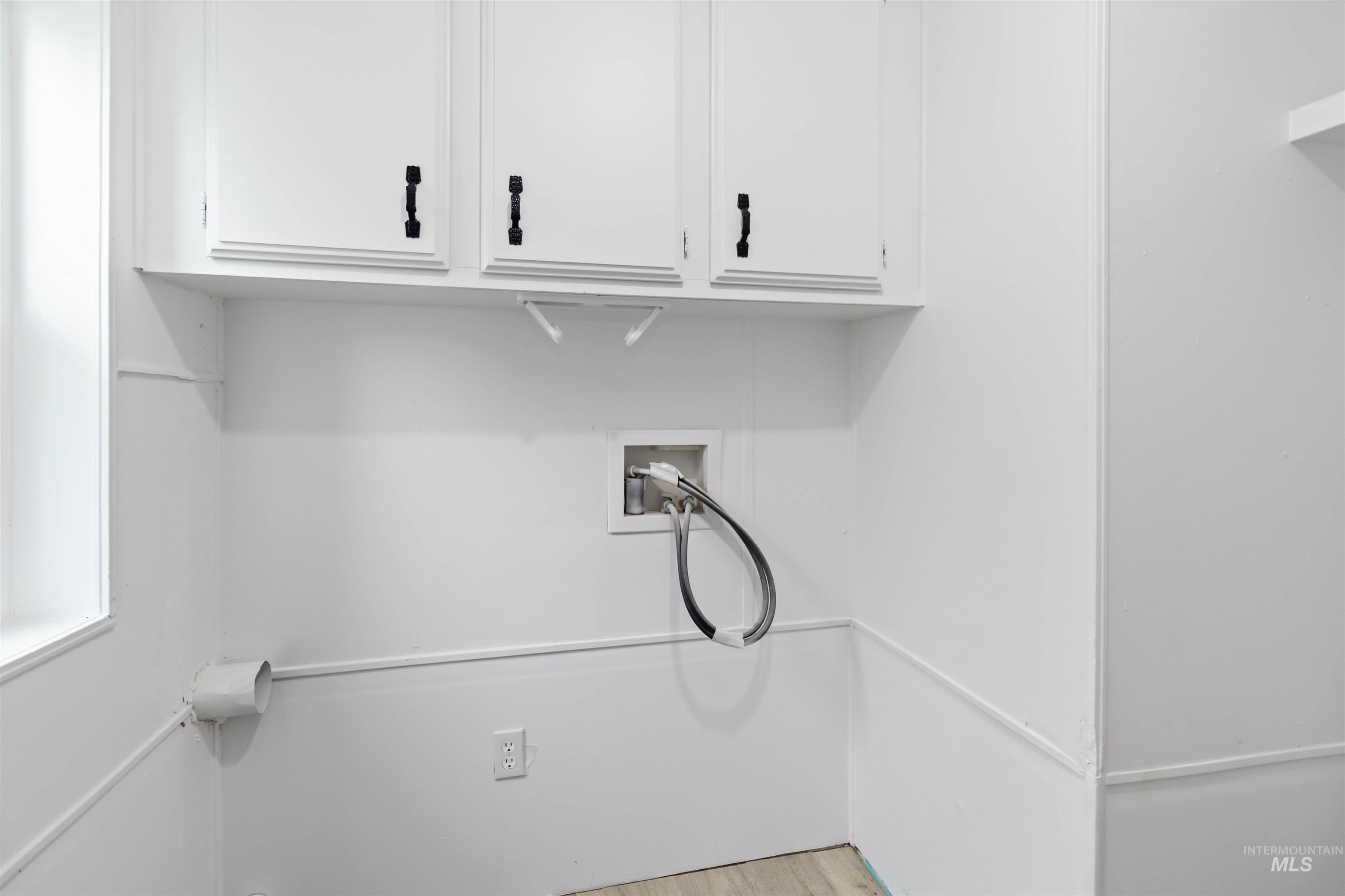 Laundry room with washer hookup and light wood finished floors