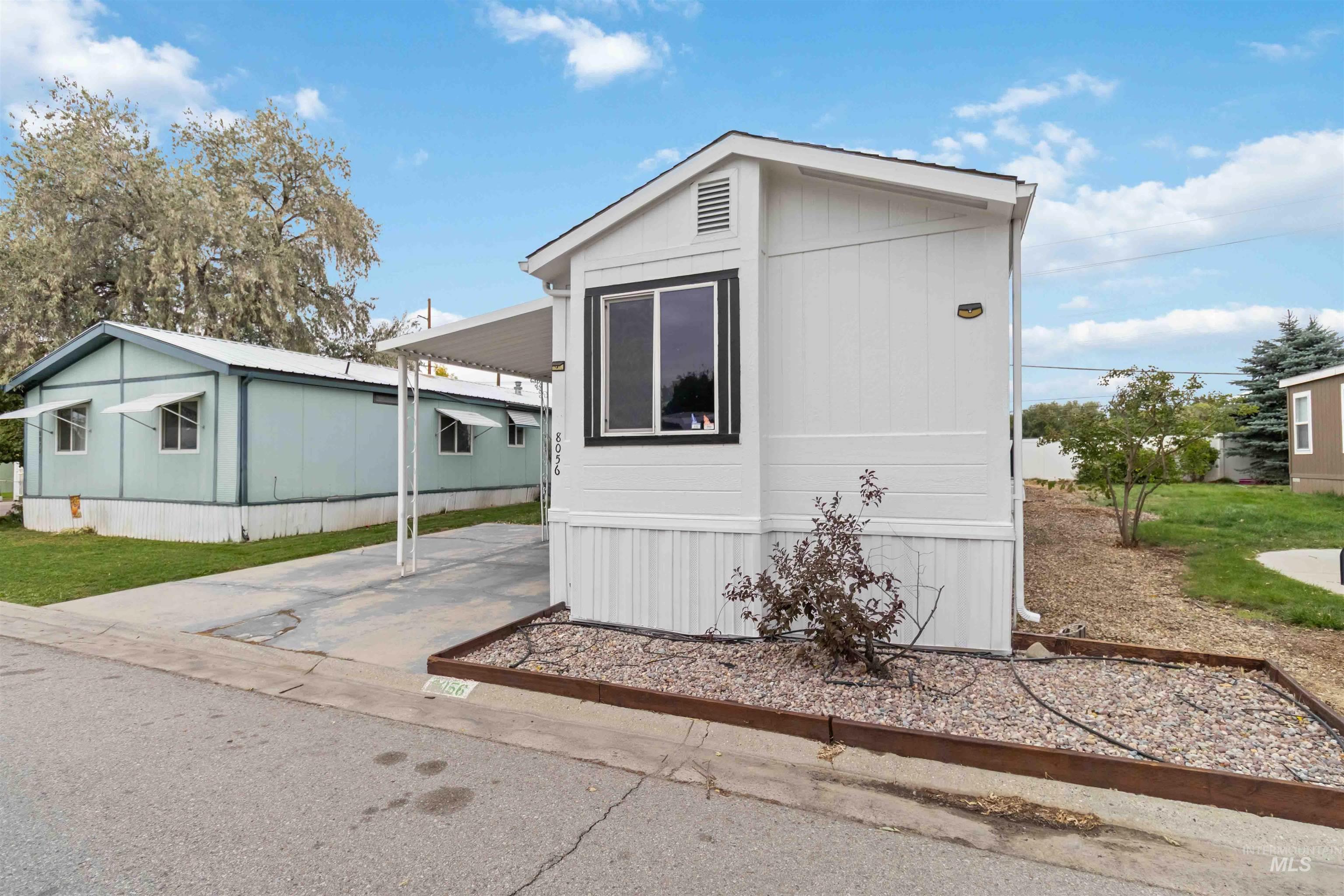 View of home's exterior with an attached carport and concrete driveway