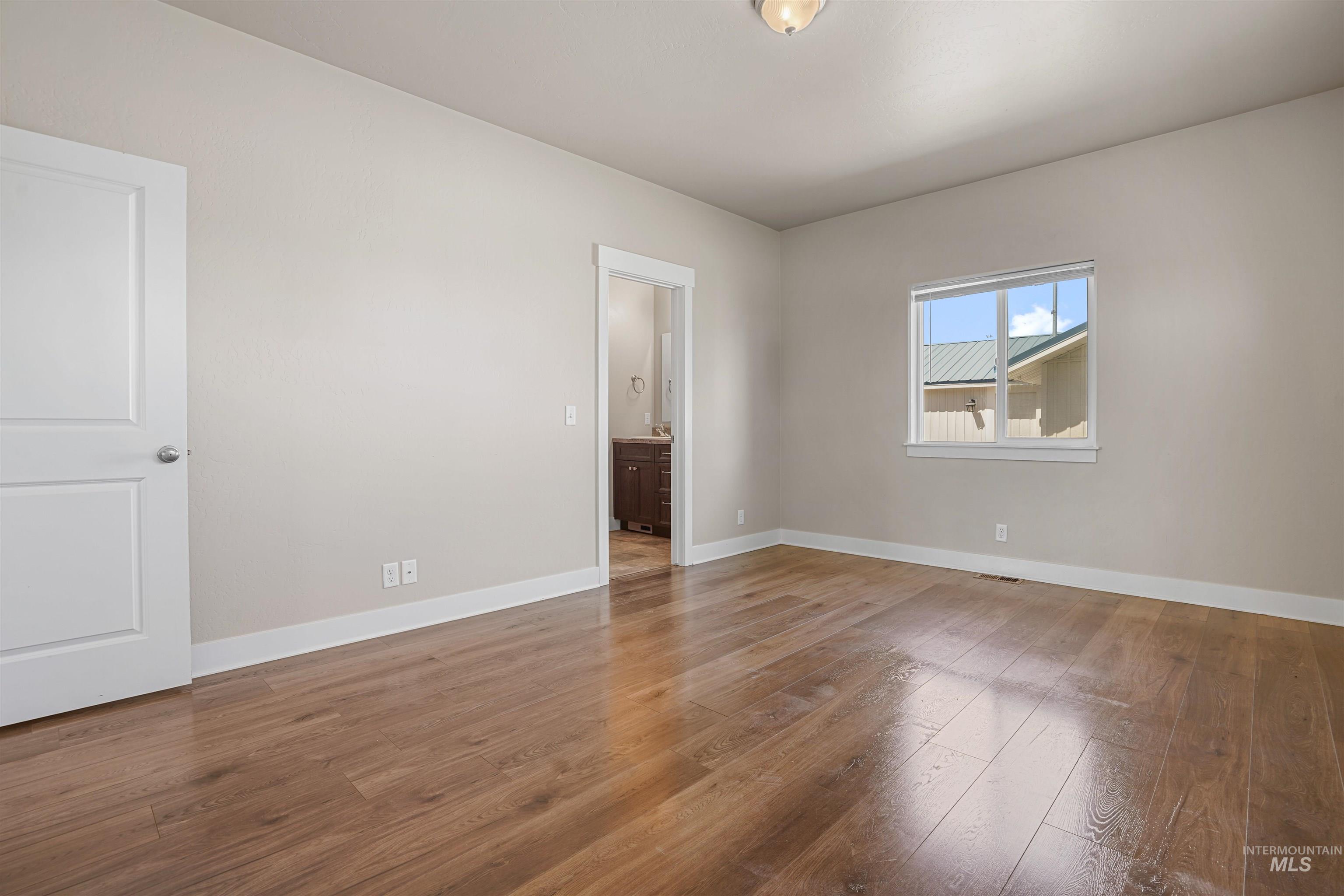 Empty room featuring wood finished floors