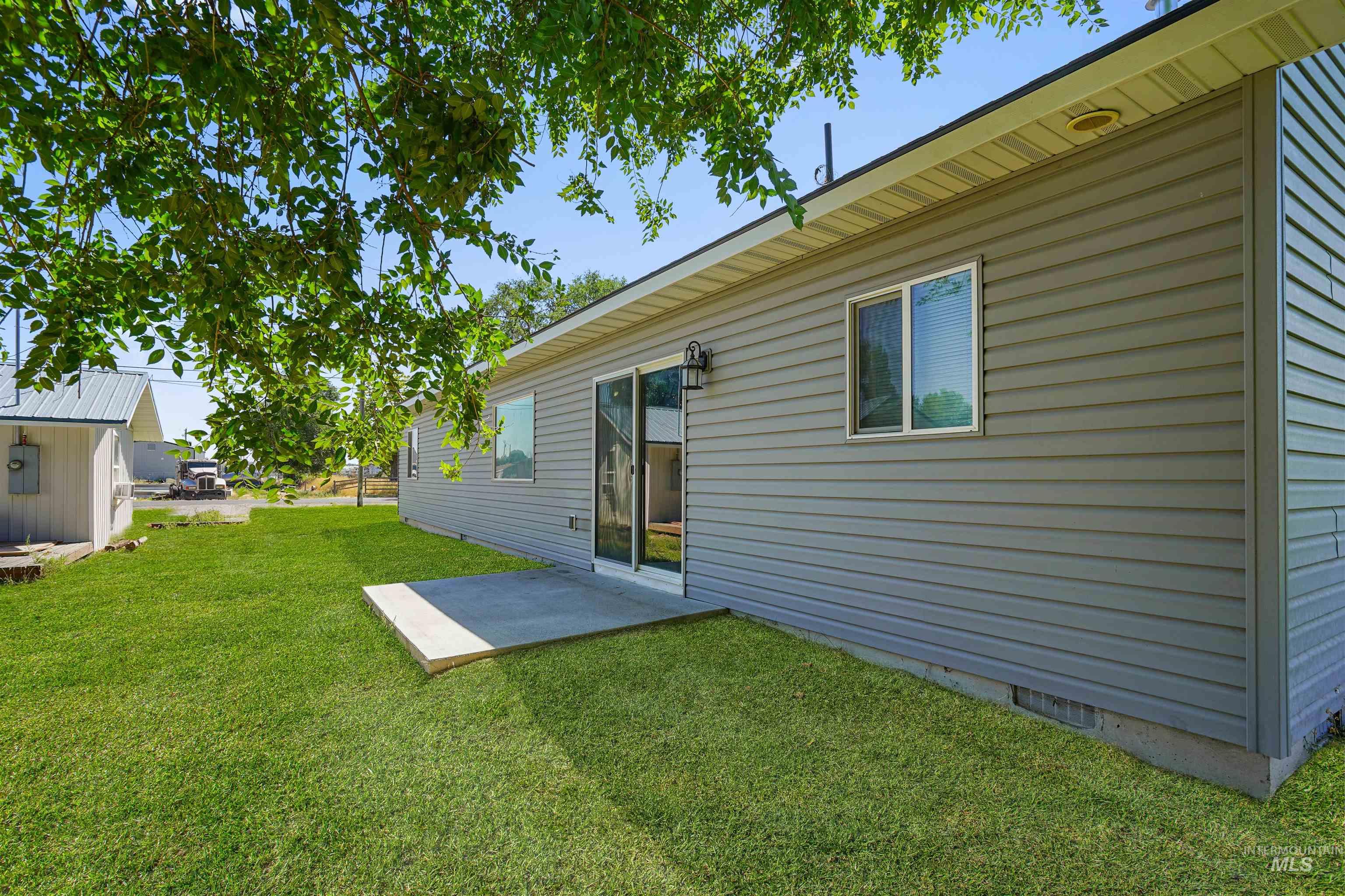 Back of house with a patio area, crawl space, and a lawn