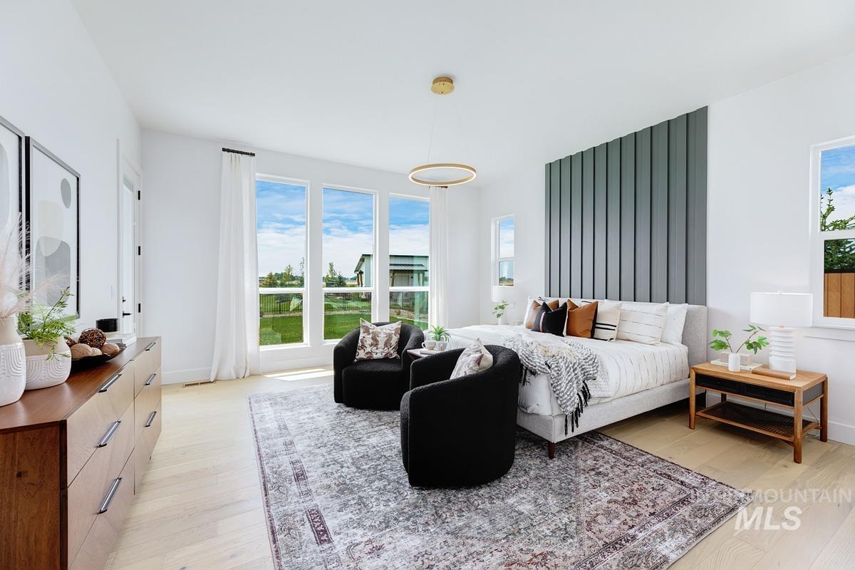 Bedroom with multiple windows and light wood-type flooring
