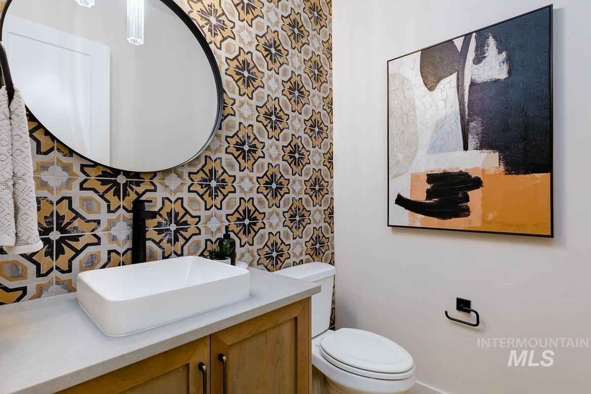 Half bathroom with vanity and toilet