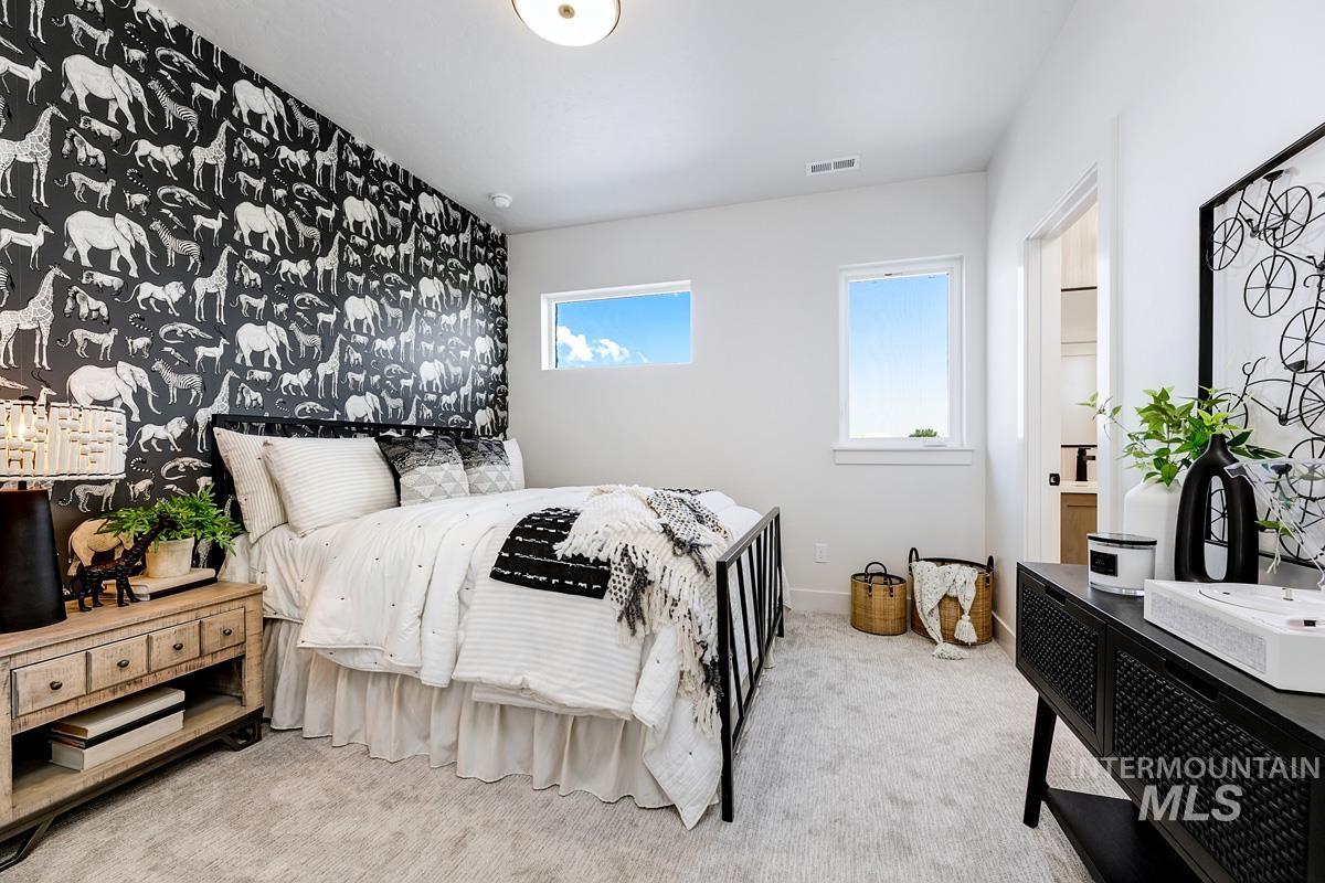 Carpeted bedroom with baseboards and connected bathroom