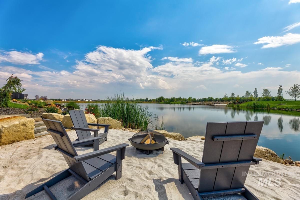 View of patio featuring a water view and a fire pit