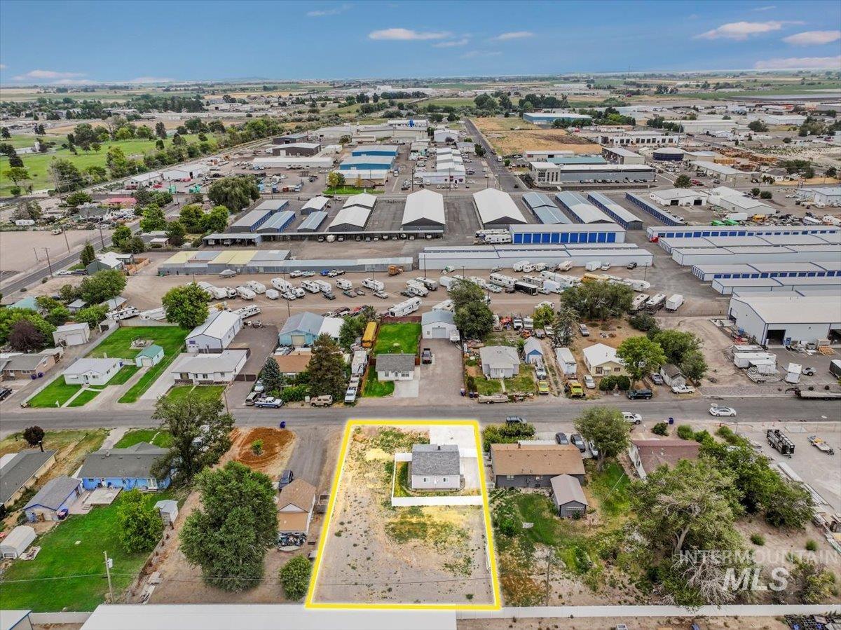 Aerial view of property's location with property parcel outlined and industrial structures