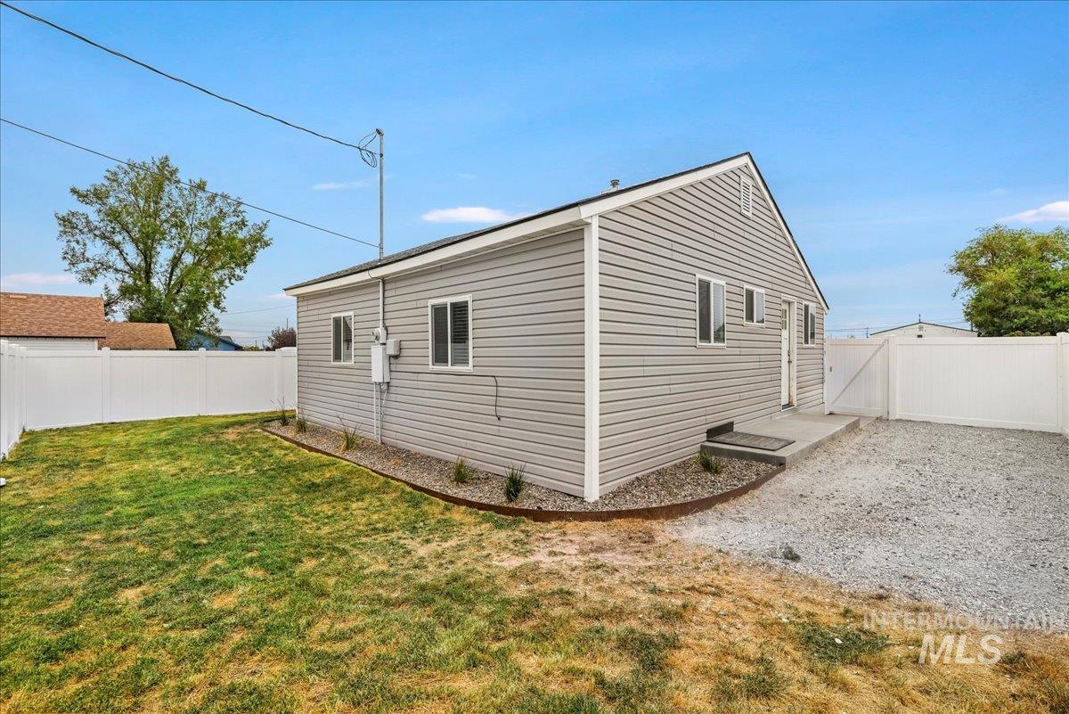 View of side of home with a fenced backyard and a patio area