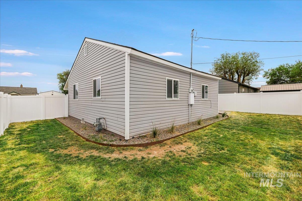 View of side of home with a fenced backyard