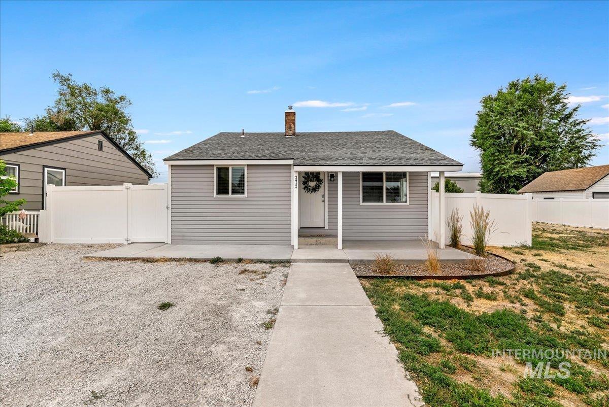 Single story home featuring a chimney and a shingled roof