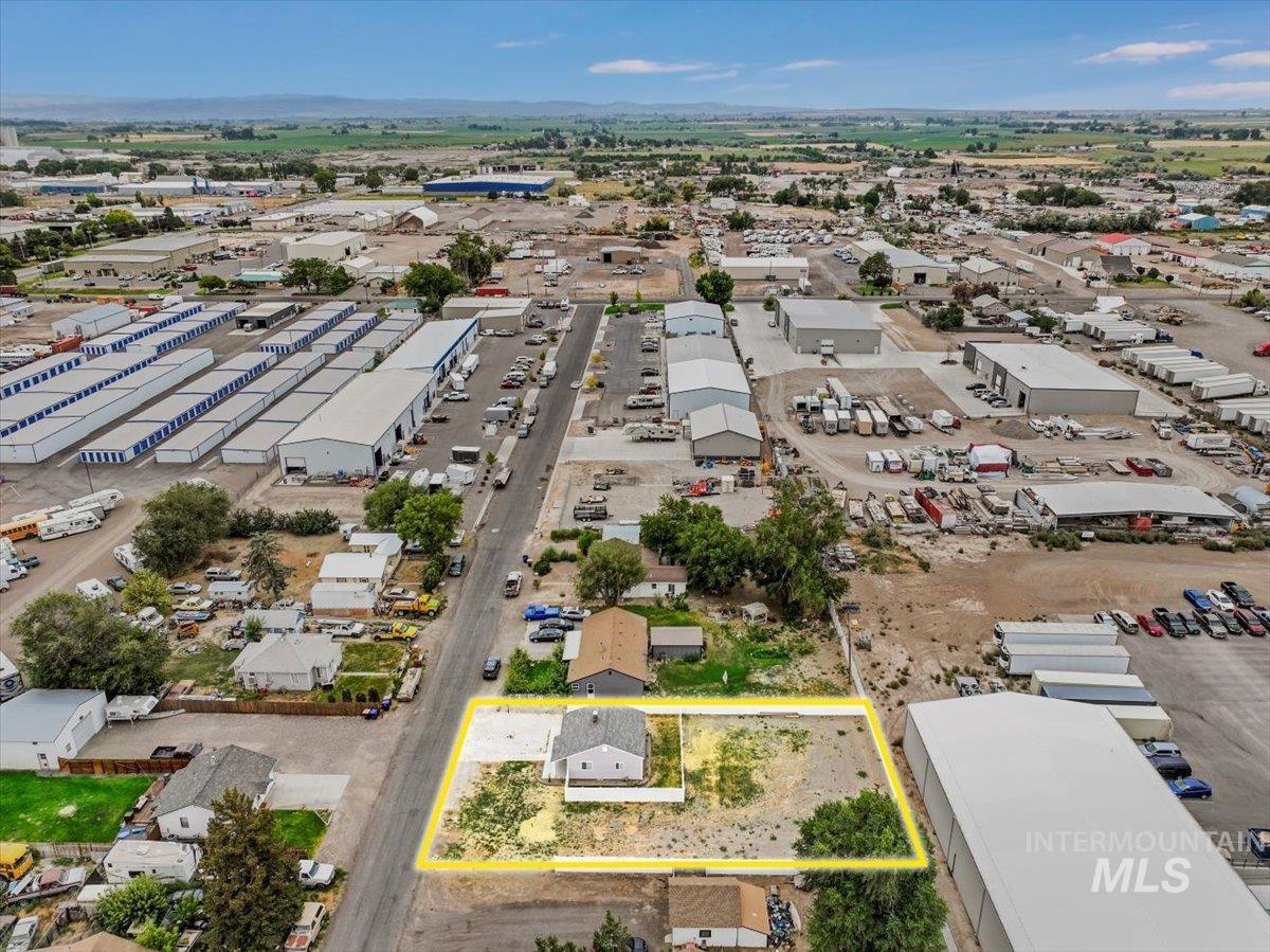 Aerial overview of property's location featuring an industrial area and property boundaries highlighted