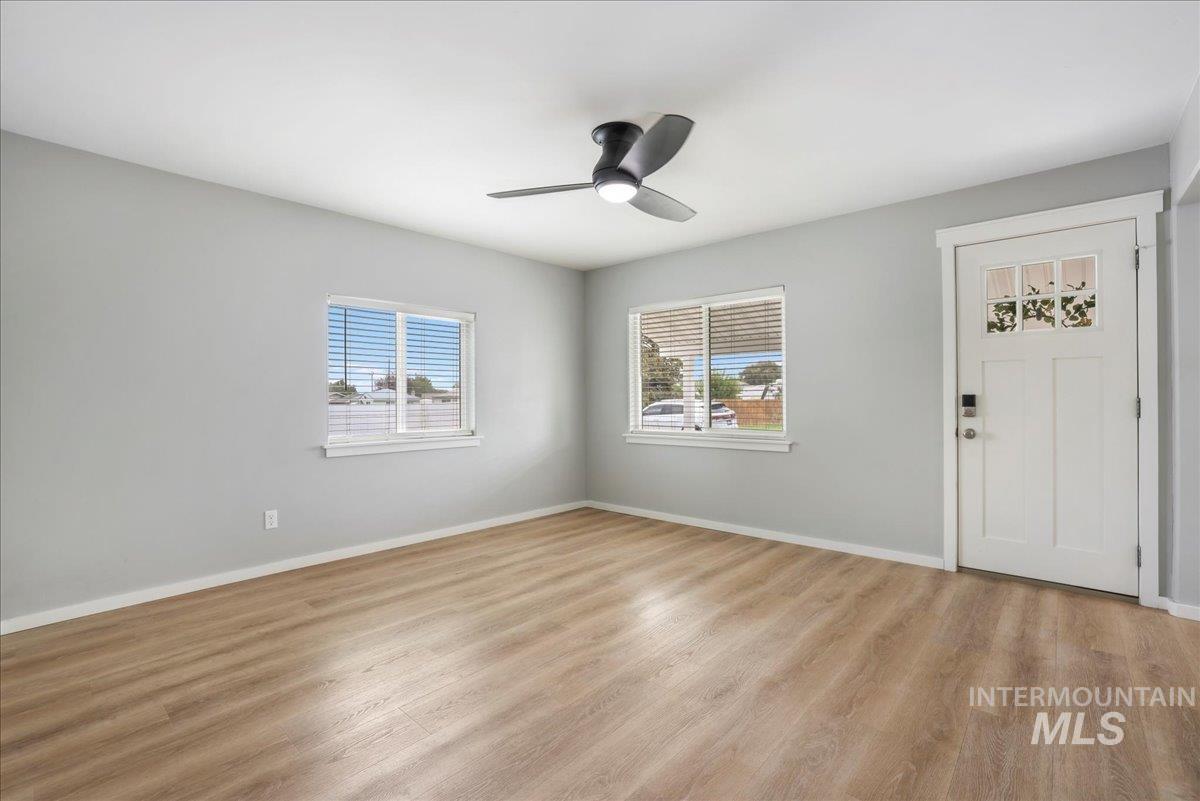 Entrance foyer featuring light wood-type flooring and ceiling fan
