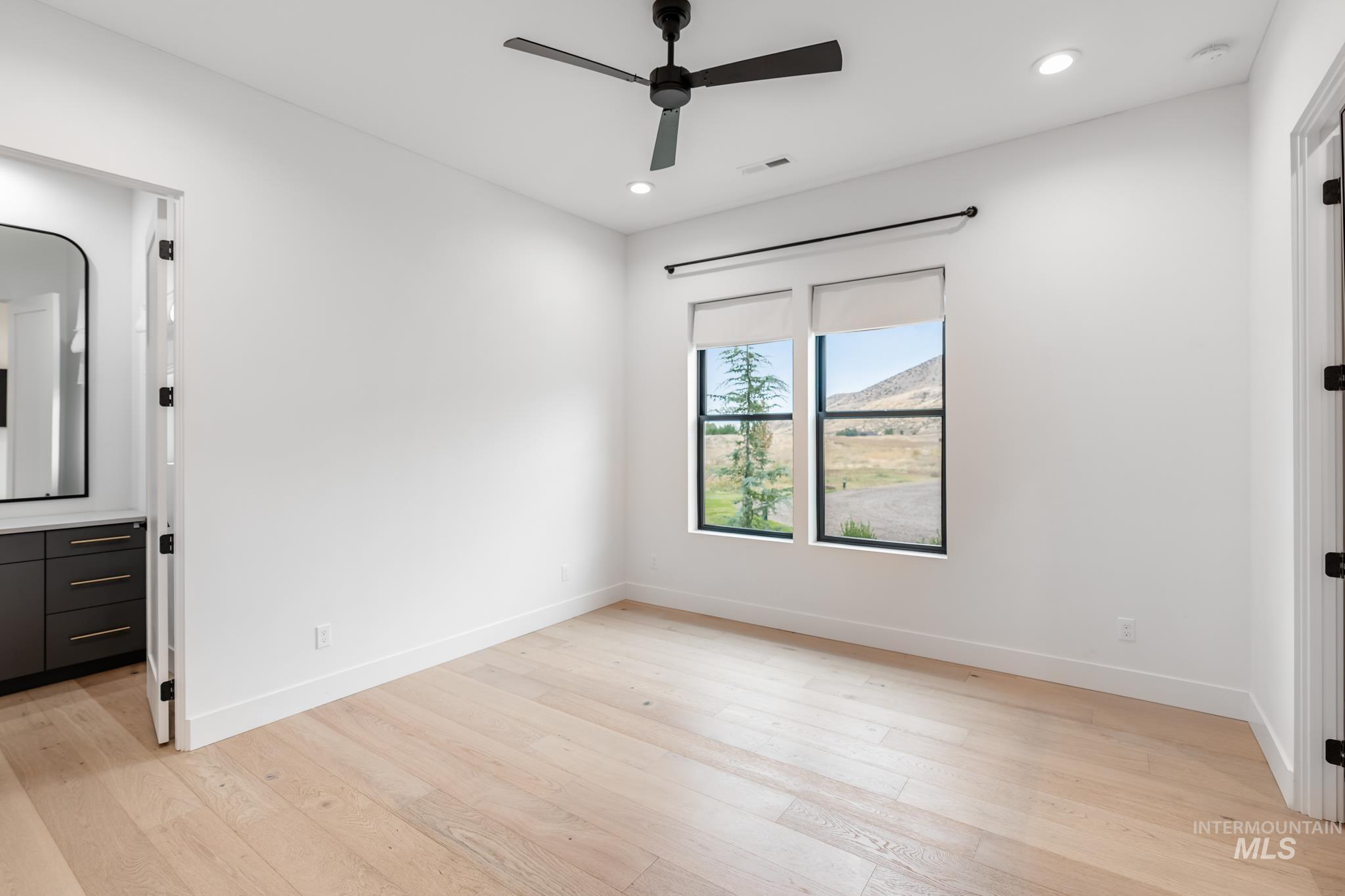Unfurnished bedroom featuring light wood-type flooring, a ceiling fan, and recessed lighting