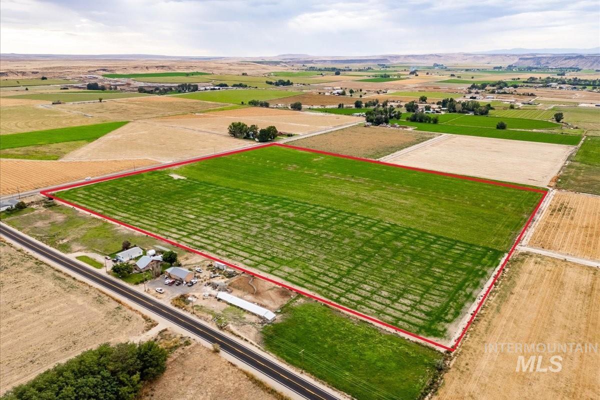 Aerial view of sparsely populated area featuring property parcel outlined and abundant farmland