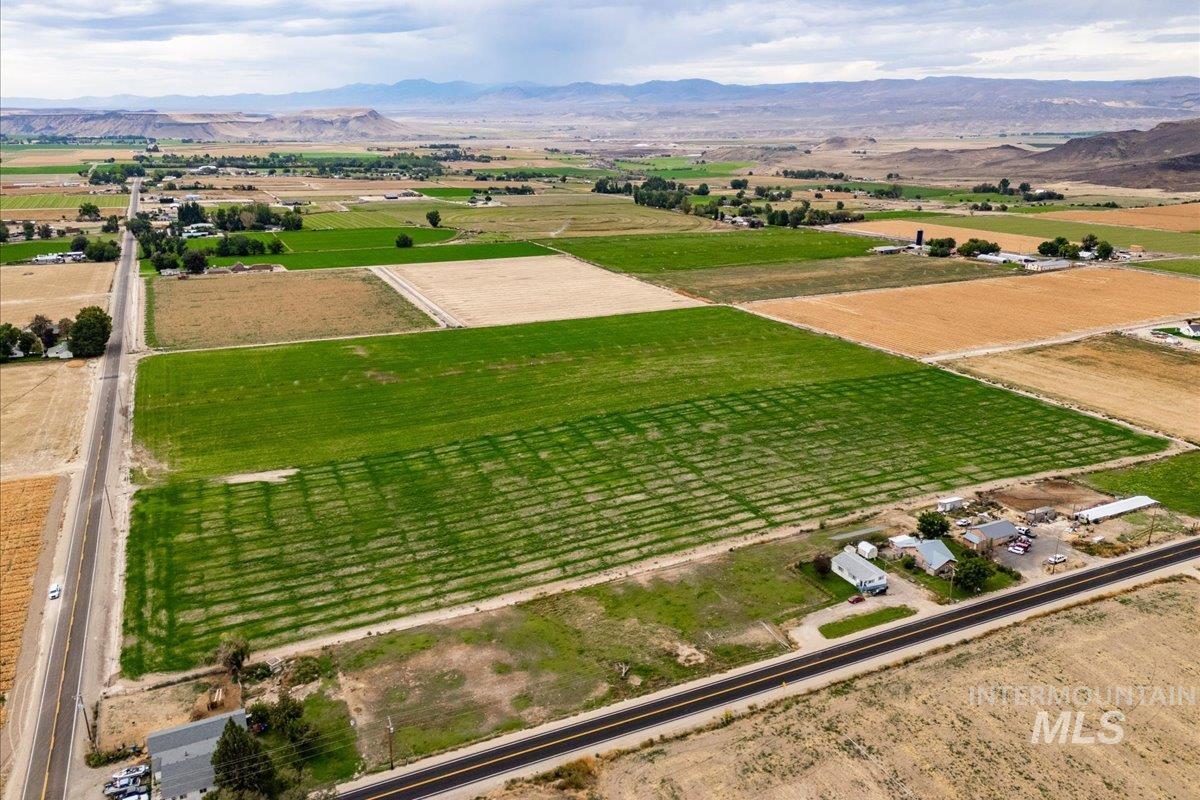 View of rural area featuring farmland and a mountain backdrop