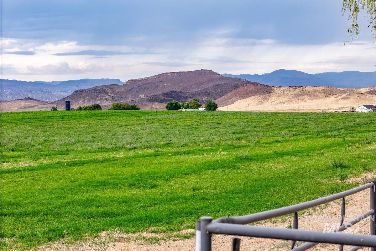 View of mountain backdrop with rural landscape