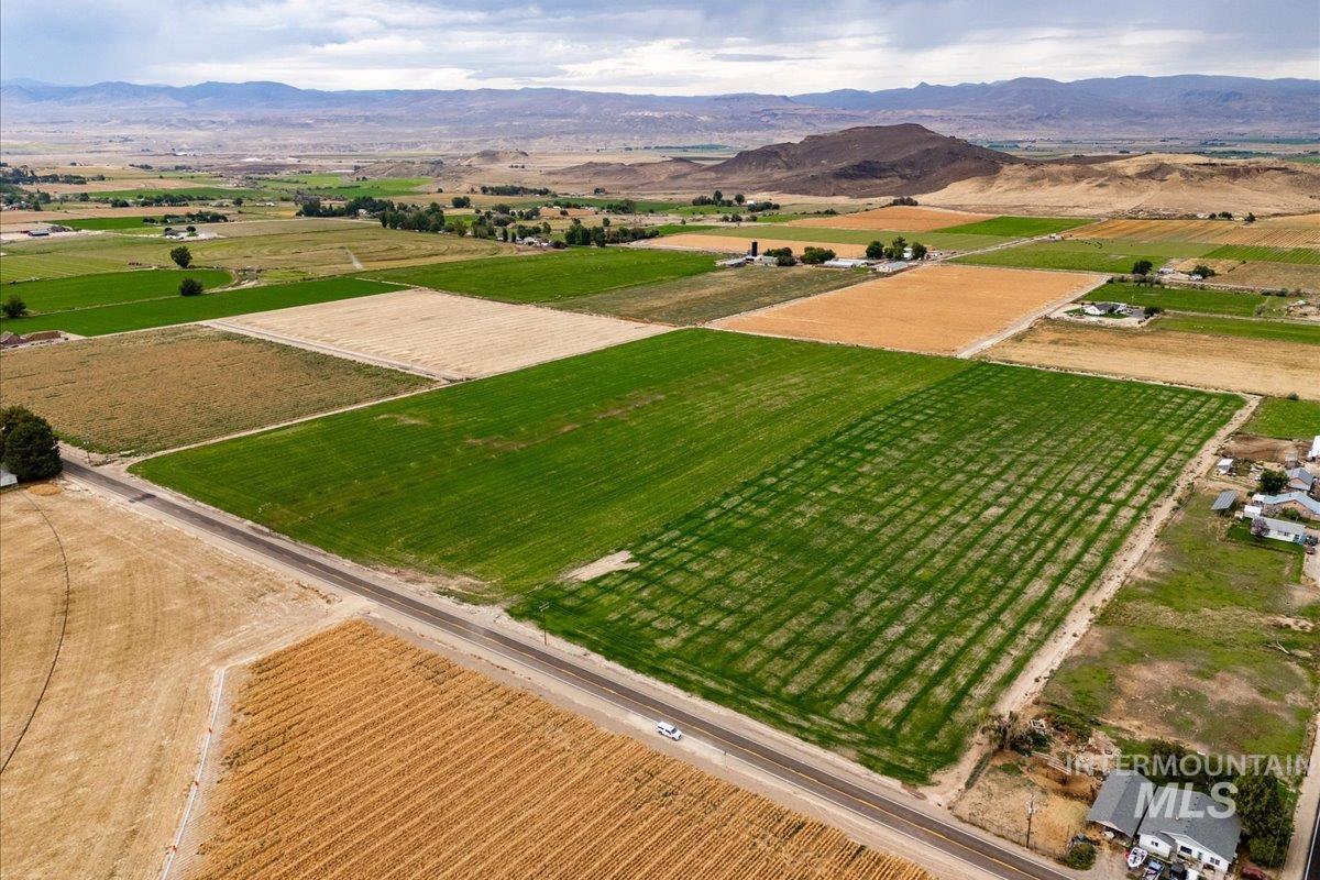 View of rural area with abundant farmland and a mountain backdrop