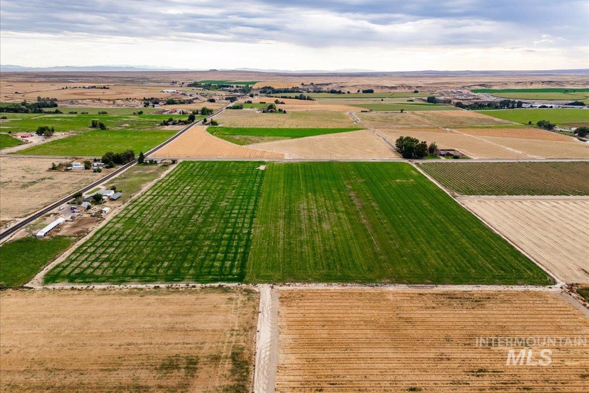 Aerial view of sparsely populated area featuring rows of crops