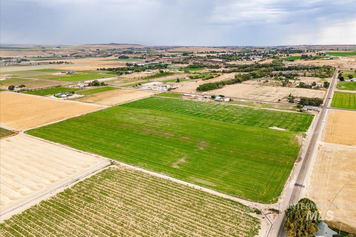 Overview of rural landscape featuring large plots for crops