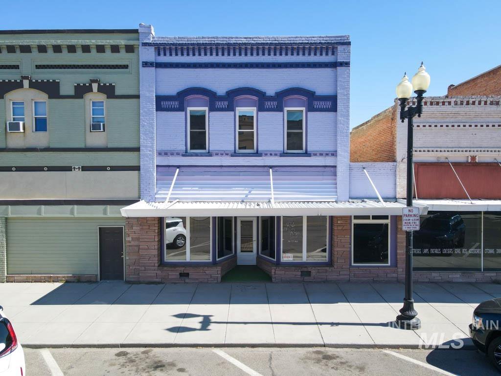View of property featuring uncovered parking